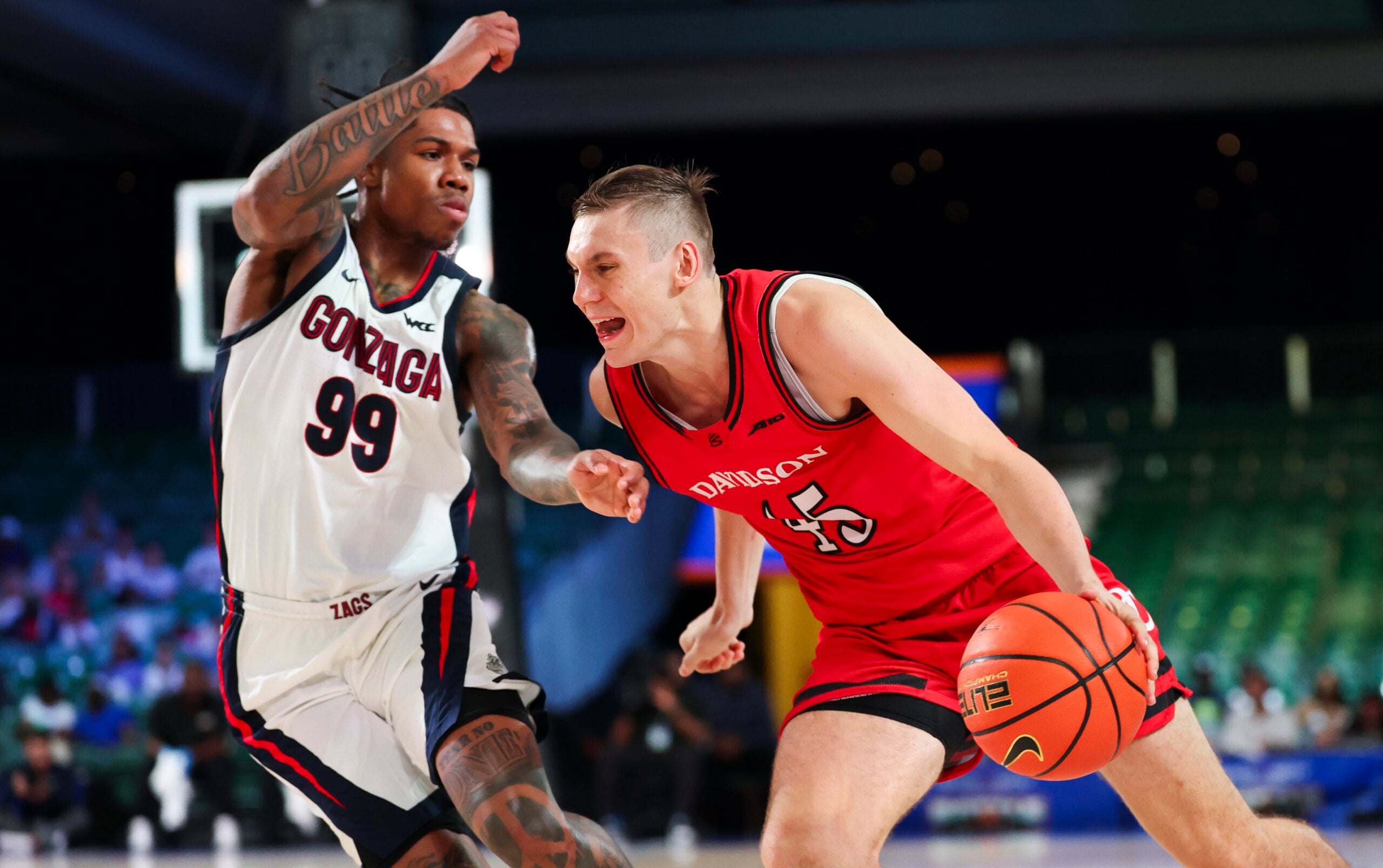 Nov 29, 2024; Paradise Island, Bahamas, BHS; Davidson Wildcats guard Roberts Blums (45) drives to the basket as Gonzaga Bulldogs guard Khalif Battle (99) defends during the second half at Imperial Arena at the Atlantis resort. Mandatory Credit: Kevin Jairaj-Imagn Images