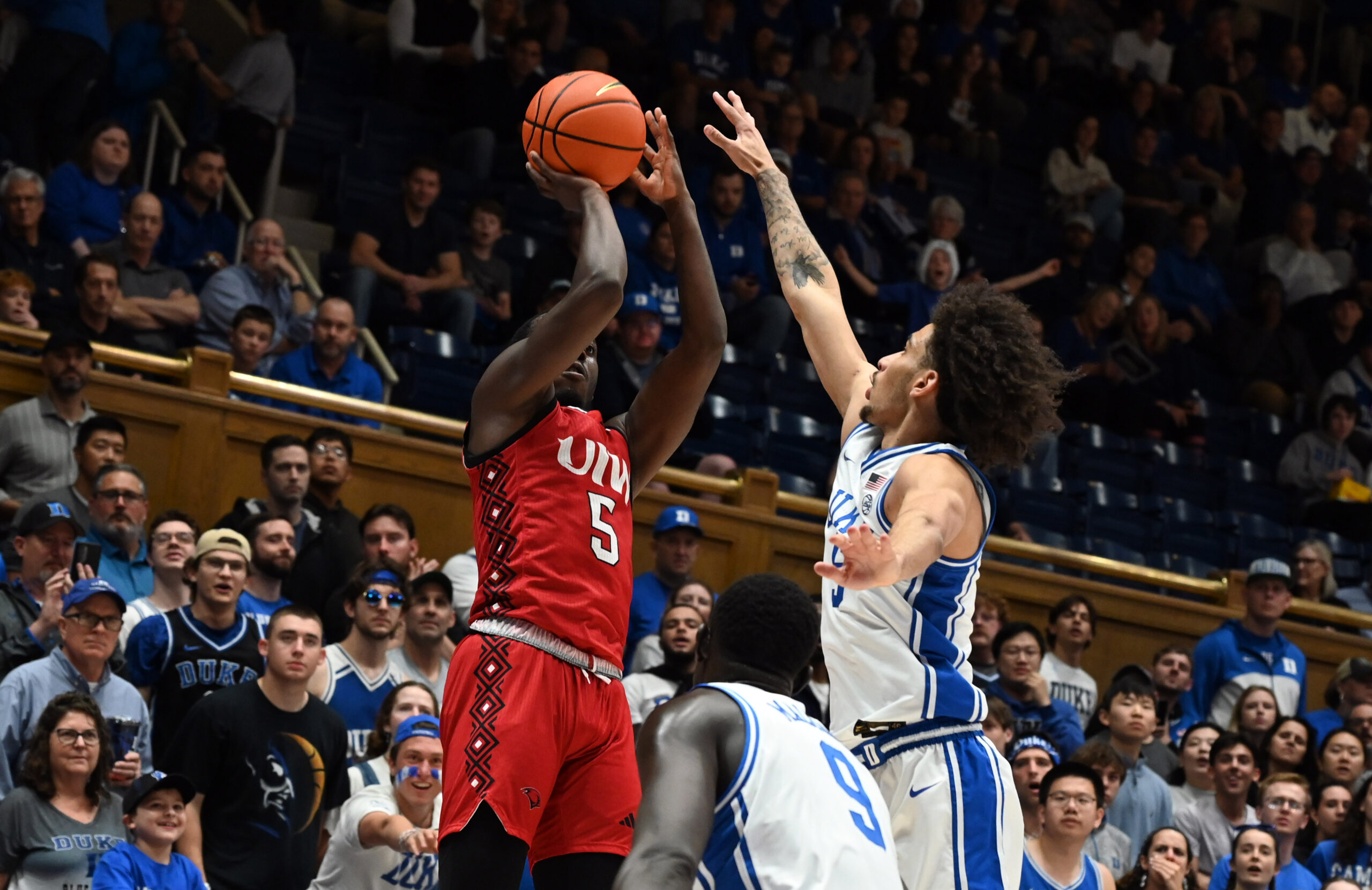 Dec 10, 2024; Durham, North Carolina, USA; dIncarnate Word Cardinals guard Davion Bailey (5) shoots over Duke Blue Devils guard Tyrese Proctor (5) uring the first half at Cameron Indoor Stadium. Mandatory Credit: Rob Kinnan-Imagn Images