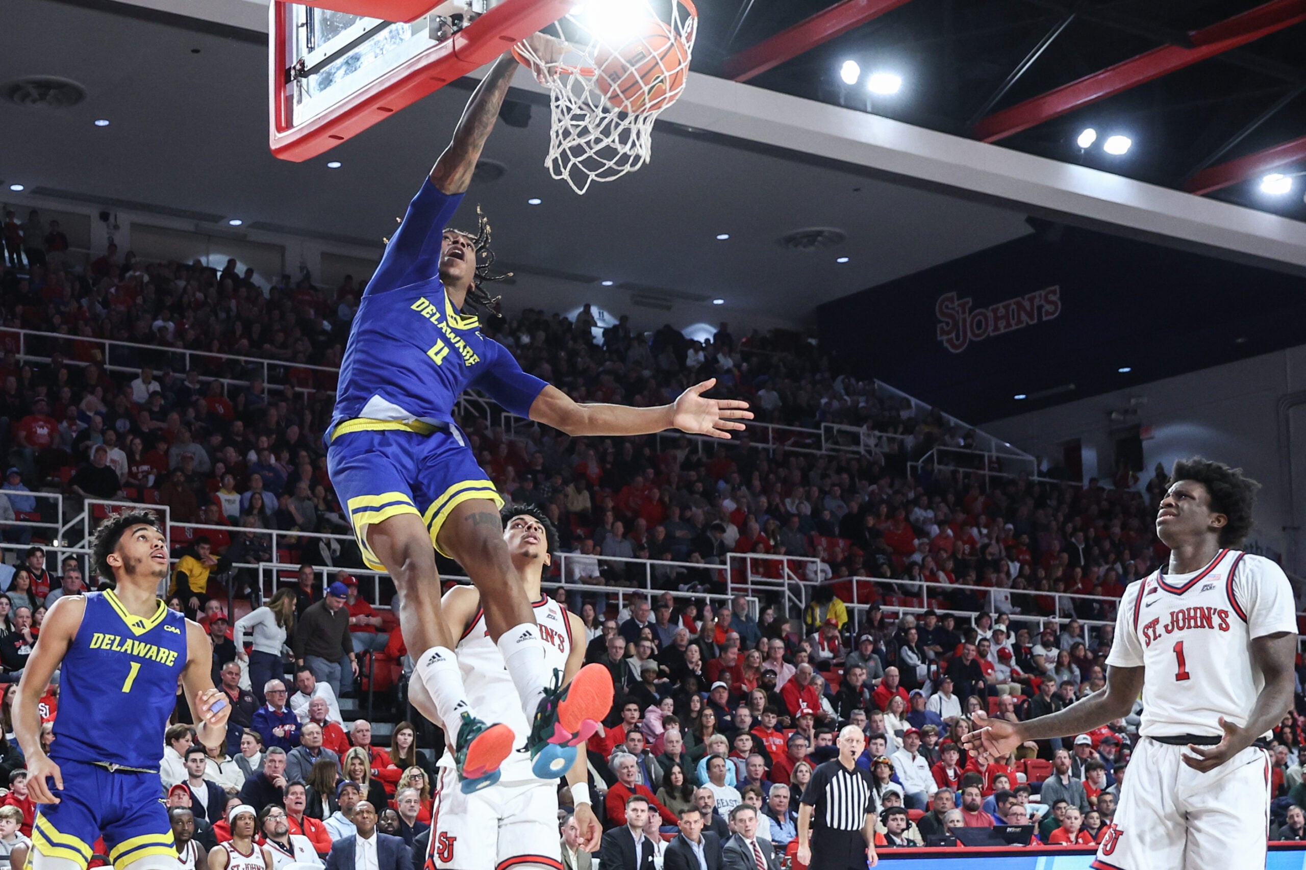 Dec 28, 2024; Queens, New York, USA; Delaware Fightin Blue Hens guard Niels Lane (4) dunks in the first half against the St. John's Red Storm at Carnesecca Arena. Mandatory Credit: Wendell Cruz-Imagn Images