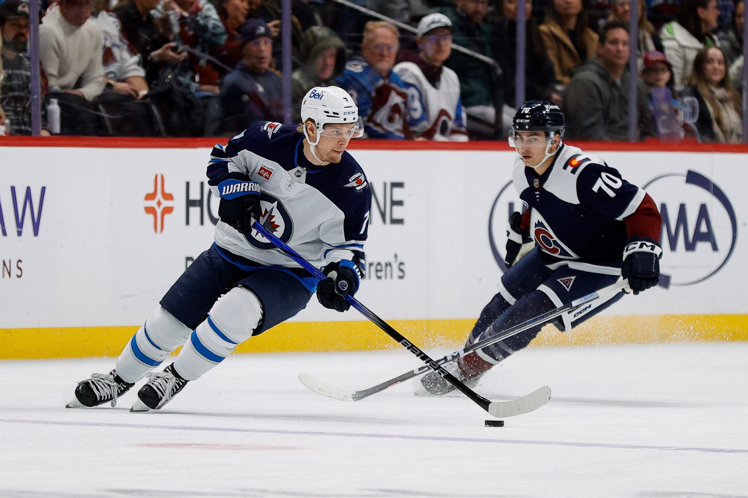 Jan 22, 2025; Denver, Colorado, USA; Winnipeg Jets center Vladislav Namestnikov (7) controls the puck ahead of Colorado Avalanche defenseman Sam Malinski (70) in the second period at Ball Arena. Mandatory Credit: Isaiah J. Downing-Imagn Images