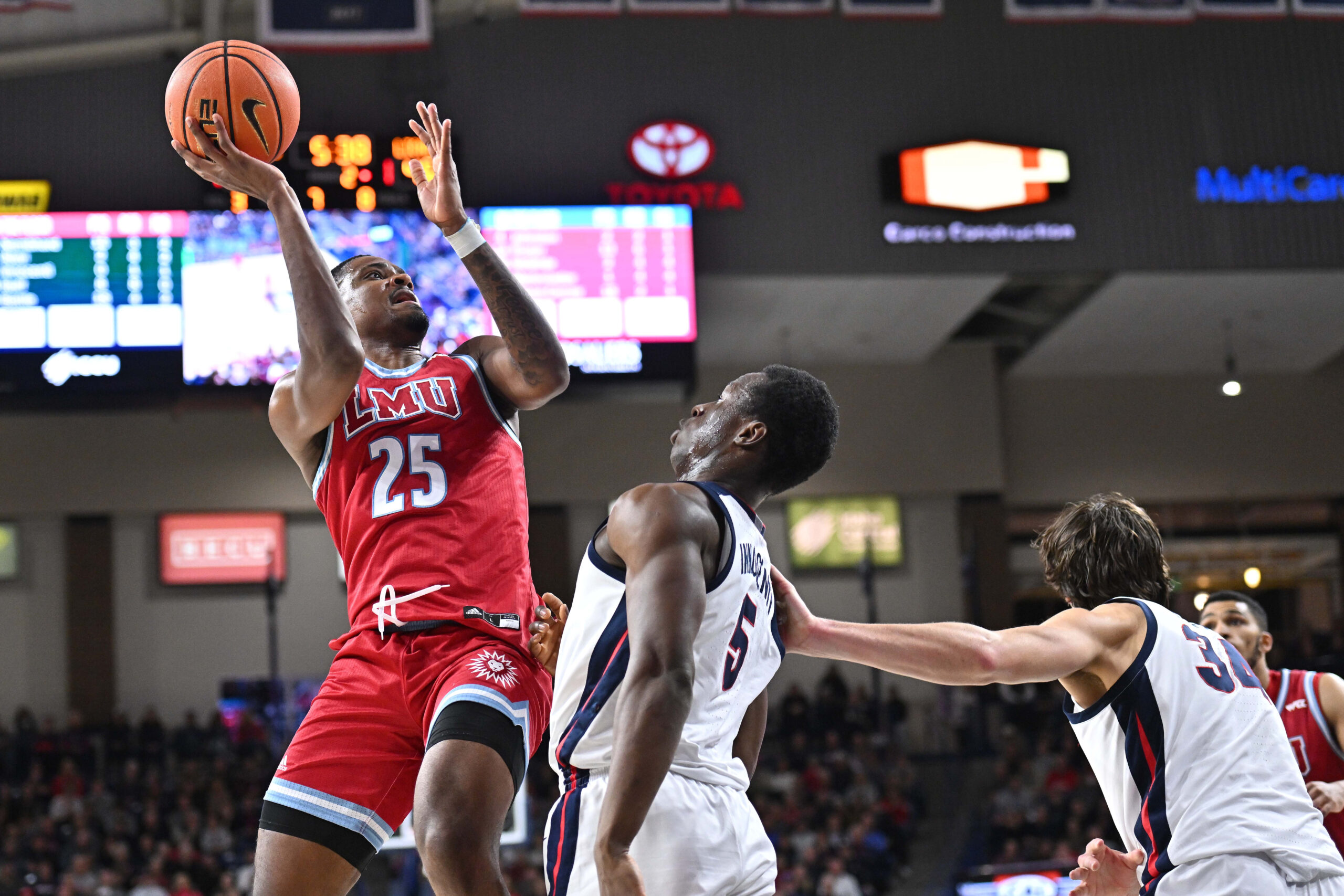 Feb 6, 2025; Spokane, Washington, USA; Loyola Marymount Lions forward Caleb Stone-Carrawell (25) shoots against Gonzaga Bulldogs forward Emmanuel Innocenti (5) in the second half at McCarthey Athletic Center. Gonzaga Bulldogs won 73-53. Mandatory Credit: James Snook-Imagn Images