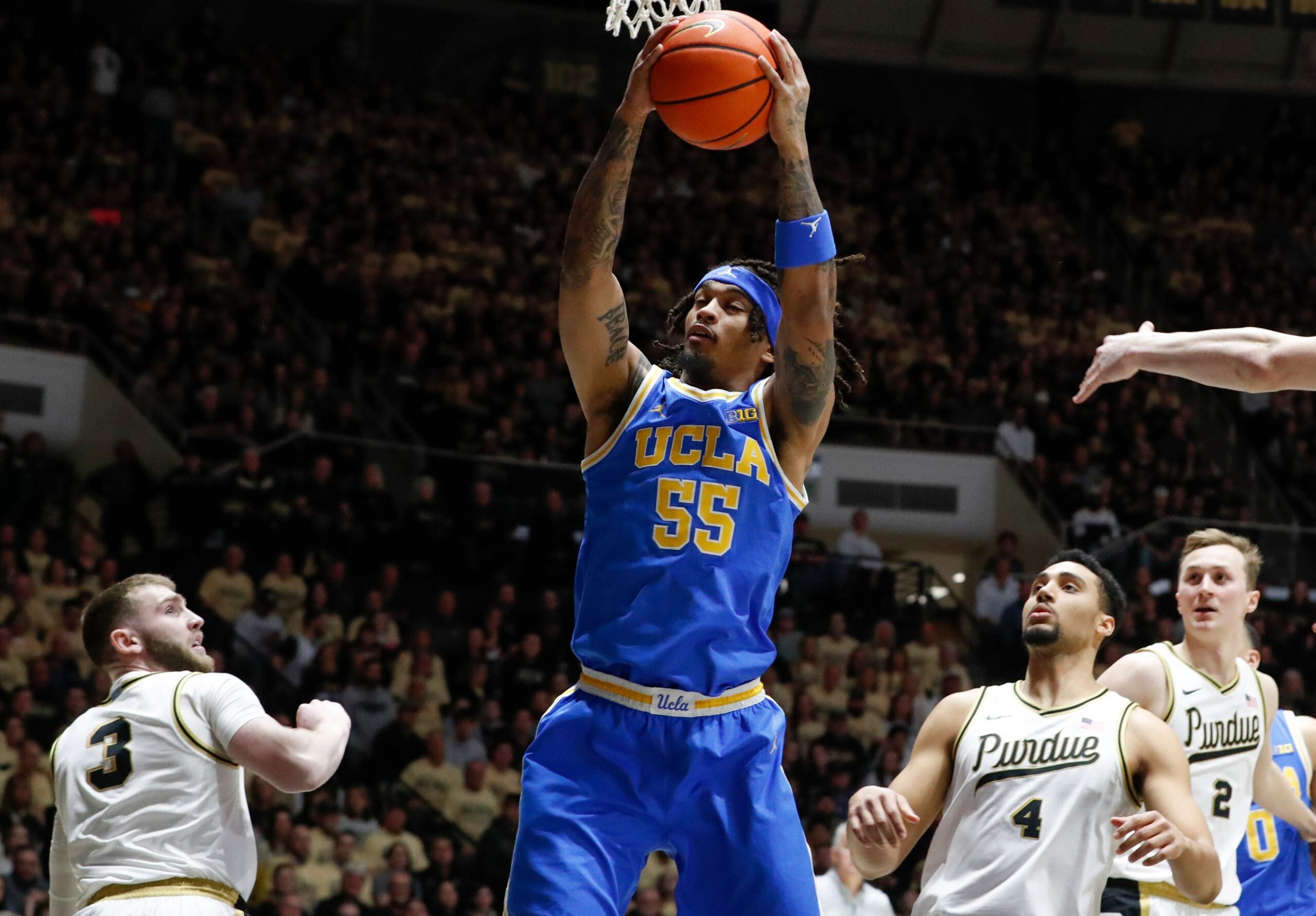 UCLA Bruins guard Skyy Clark (55) grabs a rebound Friday, Feb. 28, 2025, during the NCAA men’s basketball game against the Purdue Boilermakers at Mackey Arena in West Lafayette, Ind.