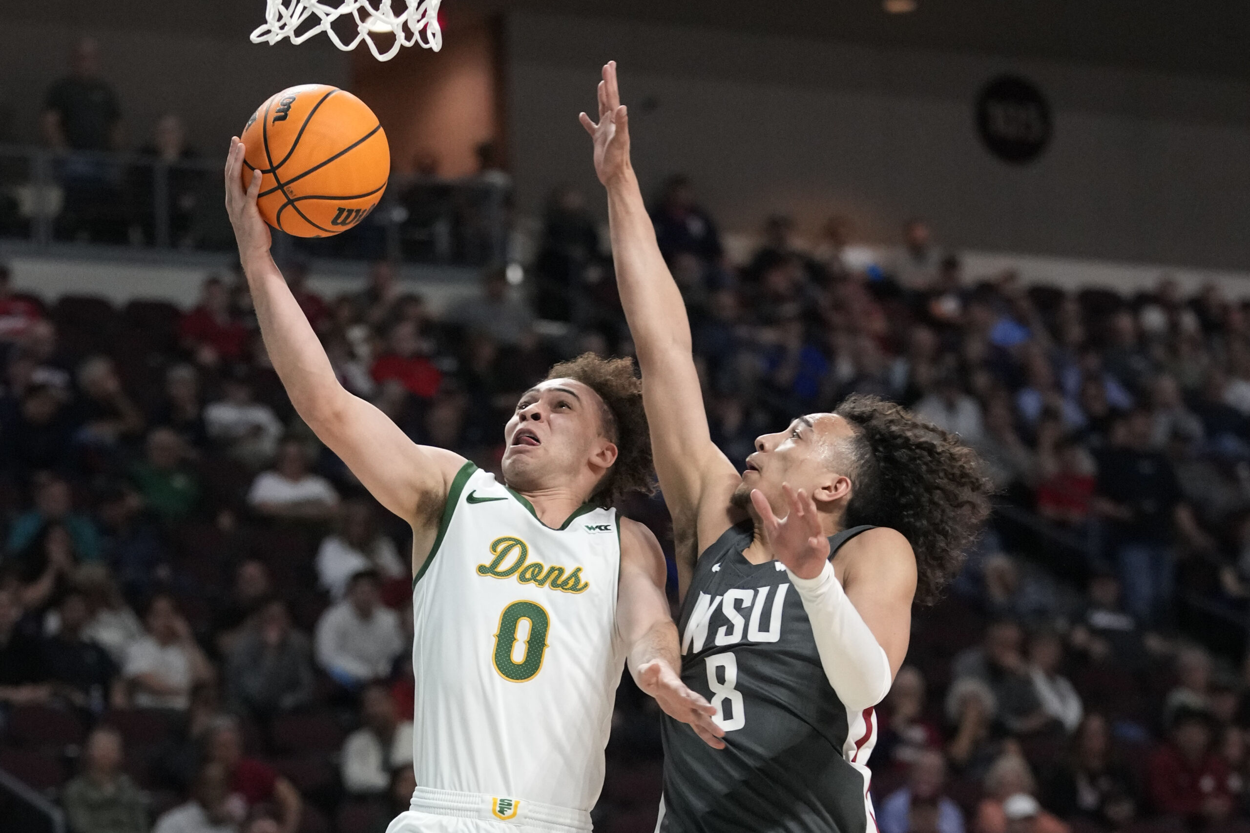 March 9, 2025; Las Vegas, NV, USA; San Francisco Dons guard Ryan Beasley (0) shoots the basketball against Washington State Cougars guard Nate Calmese (8) during the second half in the quarterfinal of the West Coast Conference tournament at Orleans Arena. Mandatory Credit: Kyle Terada-Imagn Images