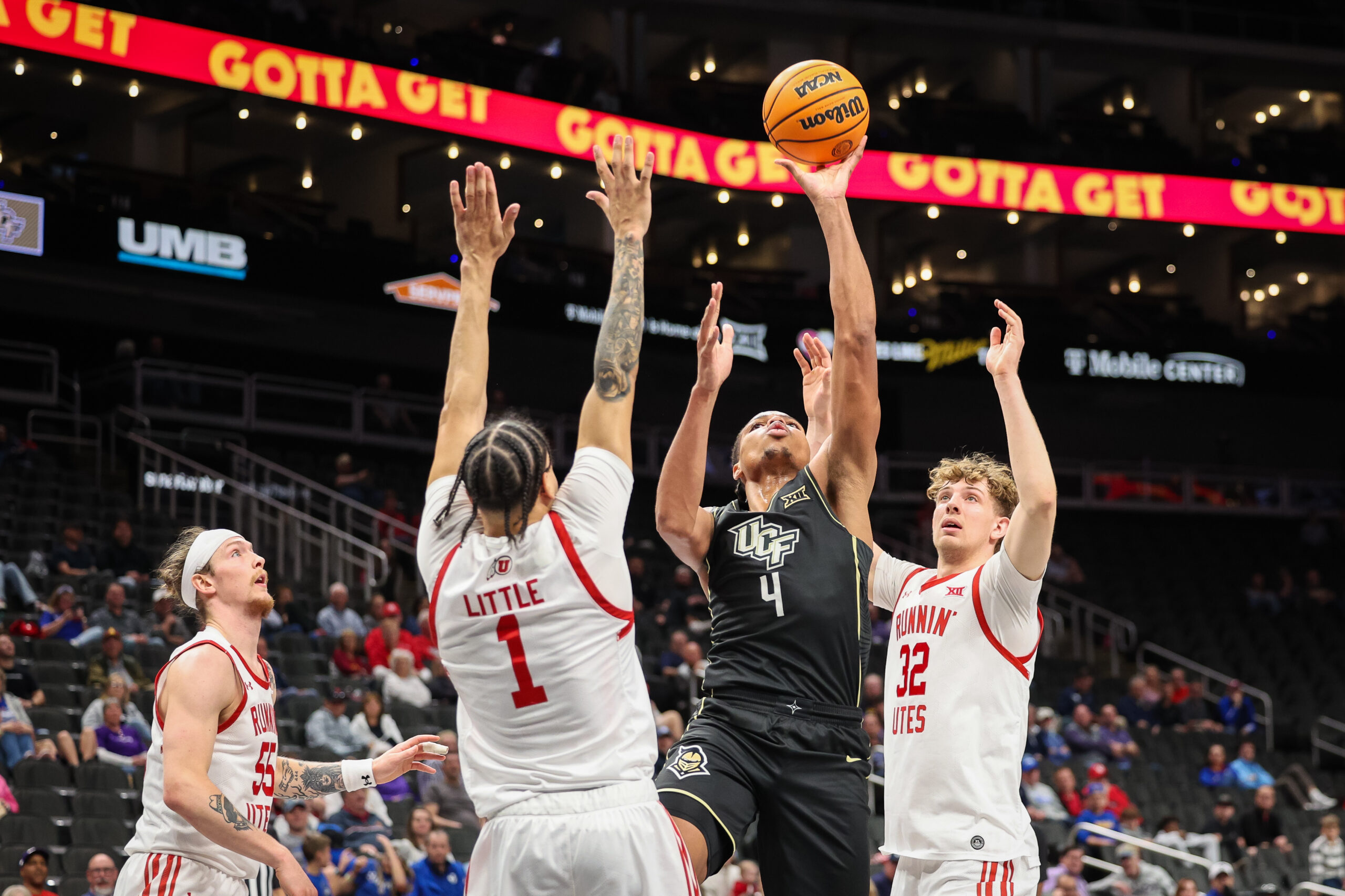 Mar 11, 2025; Kansas City, MO, USA; UCF Knights guard Keyshawn Hall (4) shoots the ball over Utah Utes guard Miro Little (1) during the second half at T-Mobile Center. Mandatory Credit: William Purnell-Imagn Images