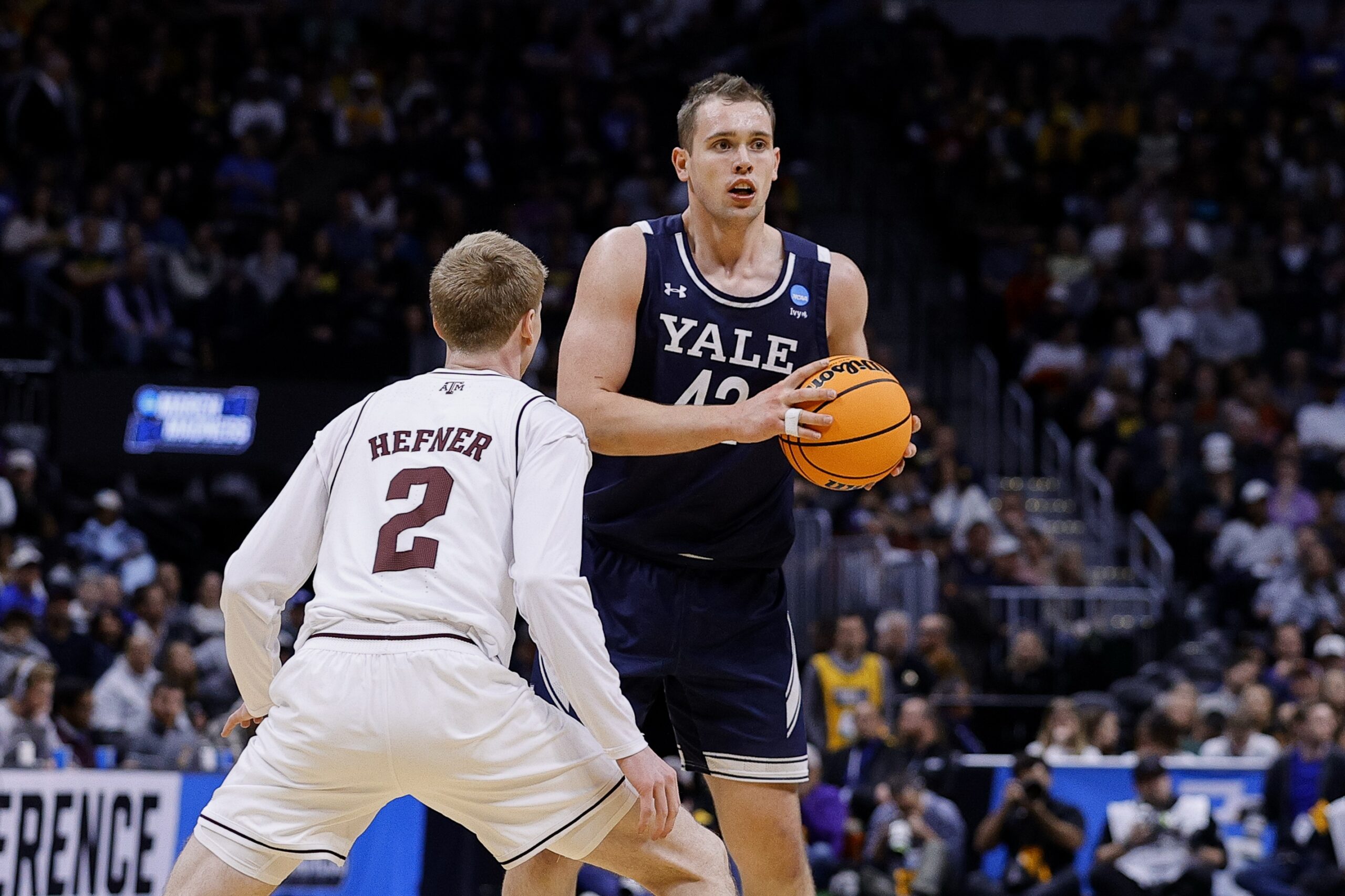 March 20, 2025; Denver, CO, USA; Yale Bulldogs forward Nick Townsend (42) looks to pass the ball as Texas A&M Aggies guard Hayden Hefner (2) defends during the second half at Ball Arena. Mandatory Credit: Isaiah J. Downing-Imagn Images