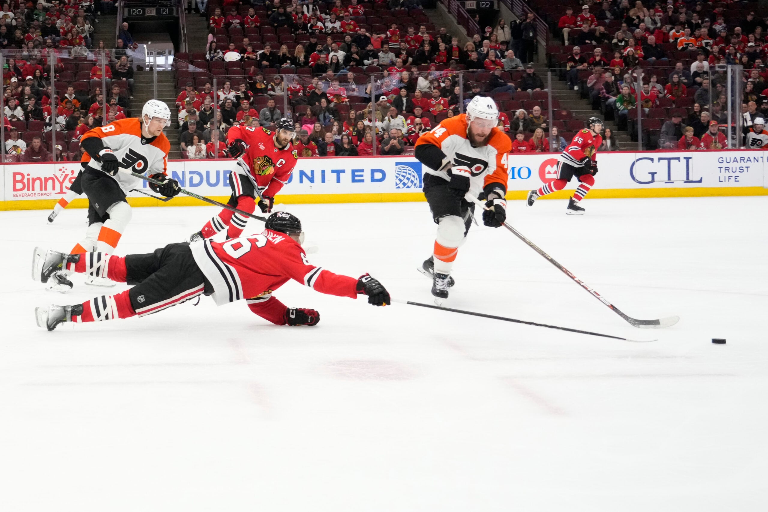 Mar 23, 2025; Chicago, Illinois, USA; Chicago Blackhawks center Teuvo Teravainen (86) and Philadelphia Flyers left wing Nicolas Deslauriers (44) go for the puck during the third period at United Center. Mandatory Credit: David Banks-Imagn Images