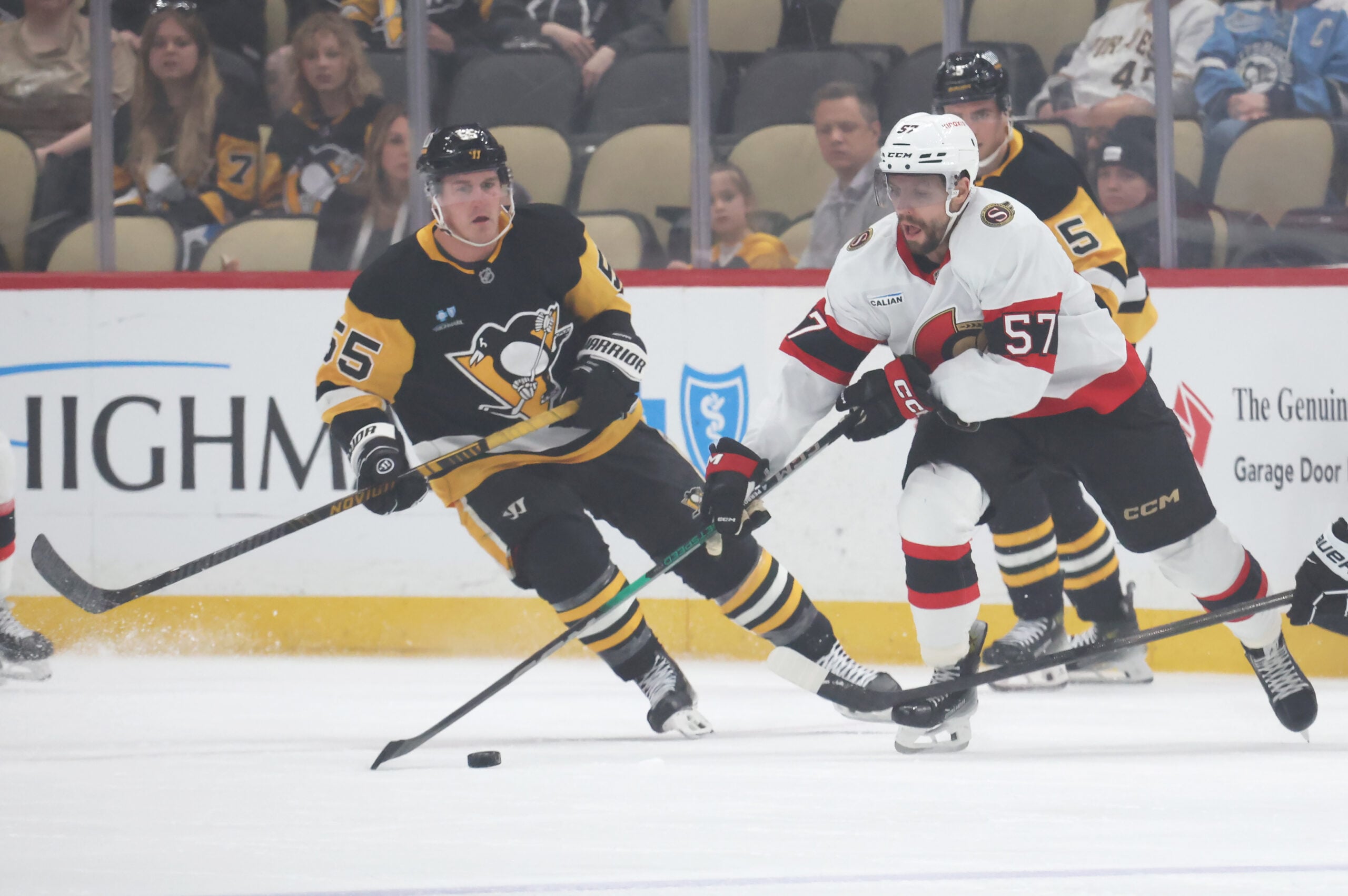 Mar 30, 2025; Pittsburgh, Pennsylvania, USA;  Ottawa Senators left wing David Perron (57) moves the puck against Pittsburgh Penguins center Noel Acciari (55) during the first period at PPG Paints Arena. Mandatory Credit: Charles LeClaire-Imagn Images