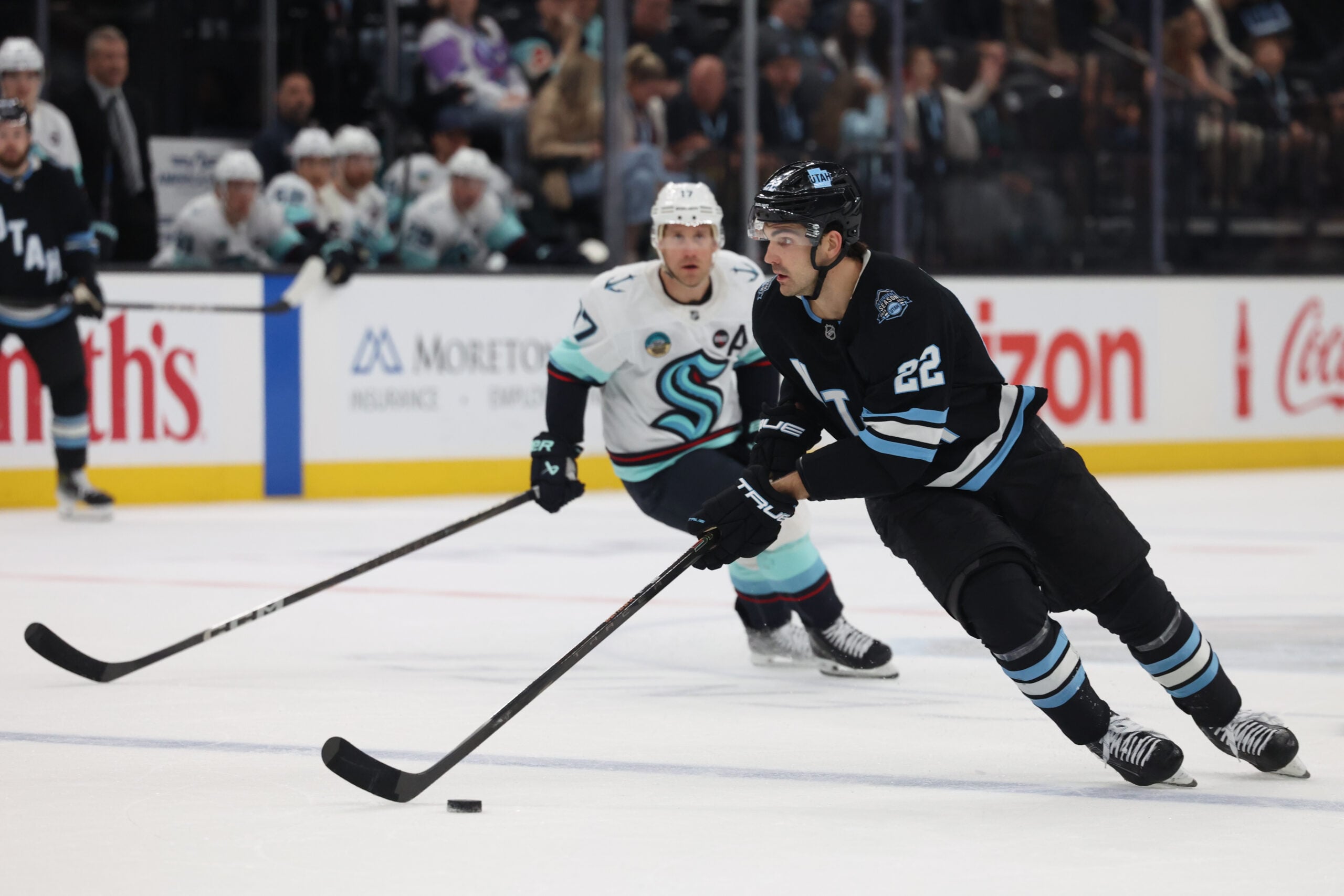 Apr 8, 2025; Salt Lake City, Utah, USA; Utah Hockey Club center Jack McBain (22) skates with the puck against the Seattle Kraken during the third period at Delta Center. Mandatory Credit: Rob Gray-Imagn Images