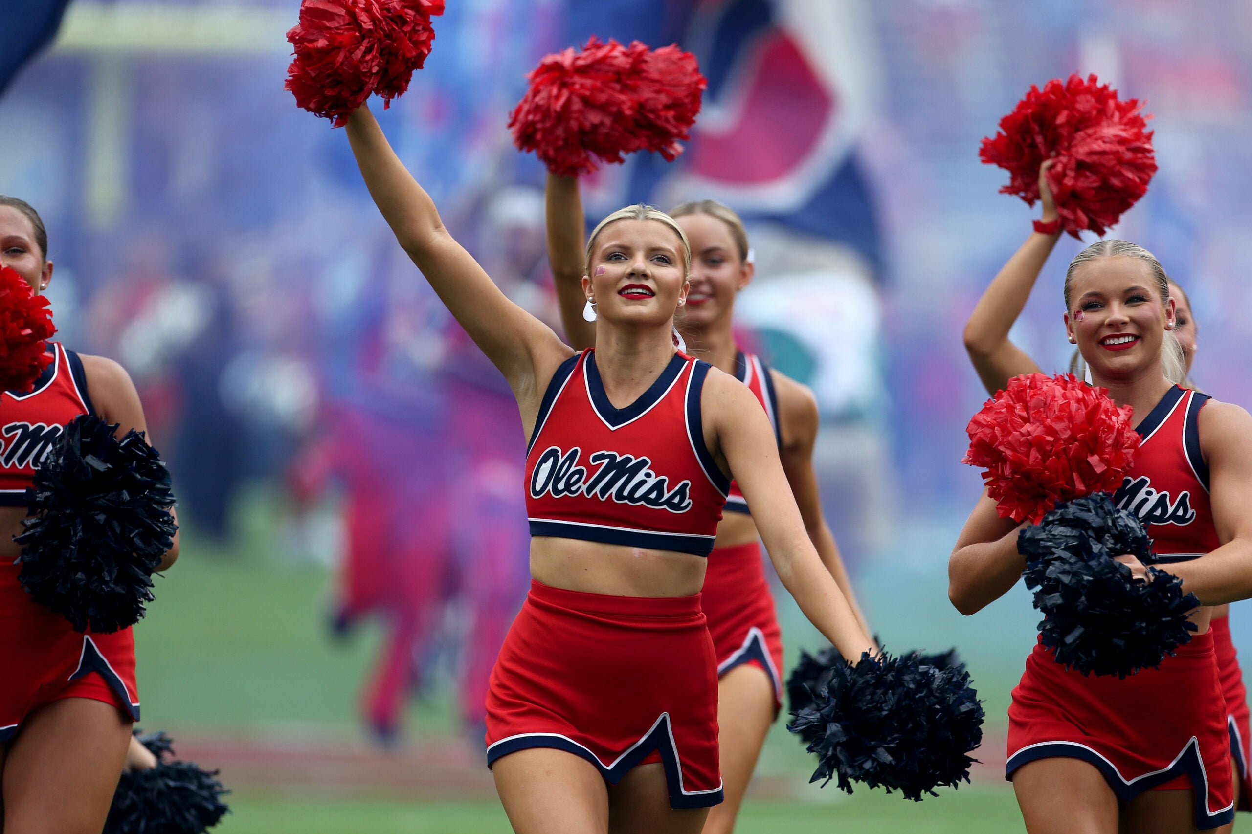 Sep 20, 2025; Oxford, Mississippi, USA; Mississippi Rebels cheerleaders lead the team onto the field prior to the game against the Tulane Green Wave at Vaught-Hemingway Stadium. Mandatory Credit: Petre Thomas-Imagn Images