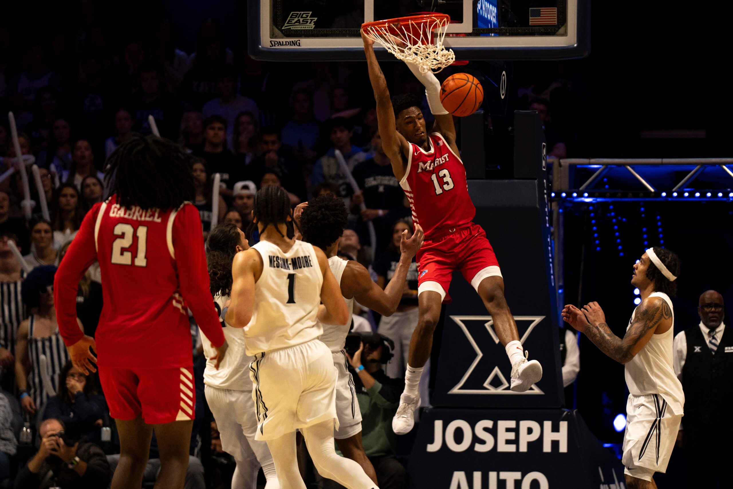 Marist Red Foxes guard Elijah Lewis (13) dunks as Marist Red Foxes guard Jadin Collins-Roberts (0) looks on in the second half of the basketball game at the Cintas Center on Nov. 3, 2025.