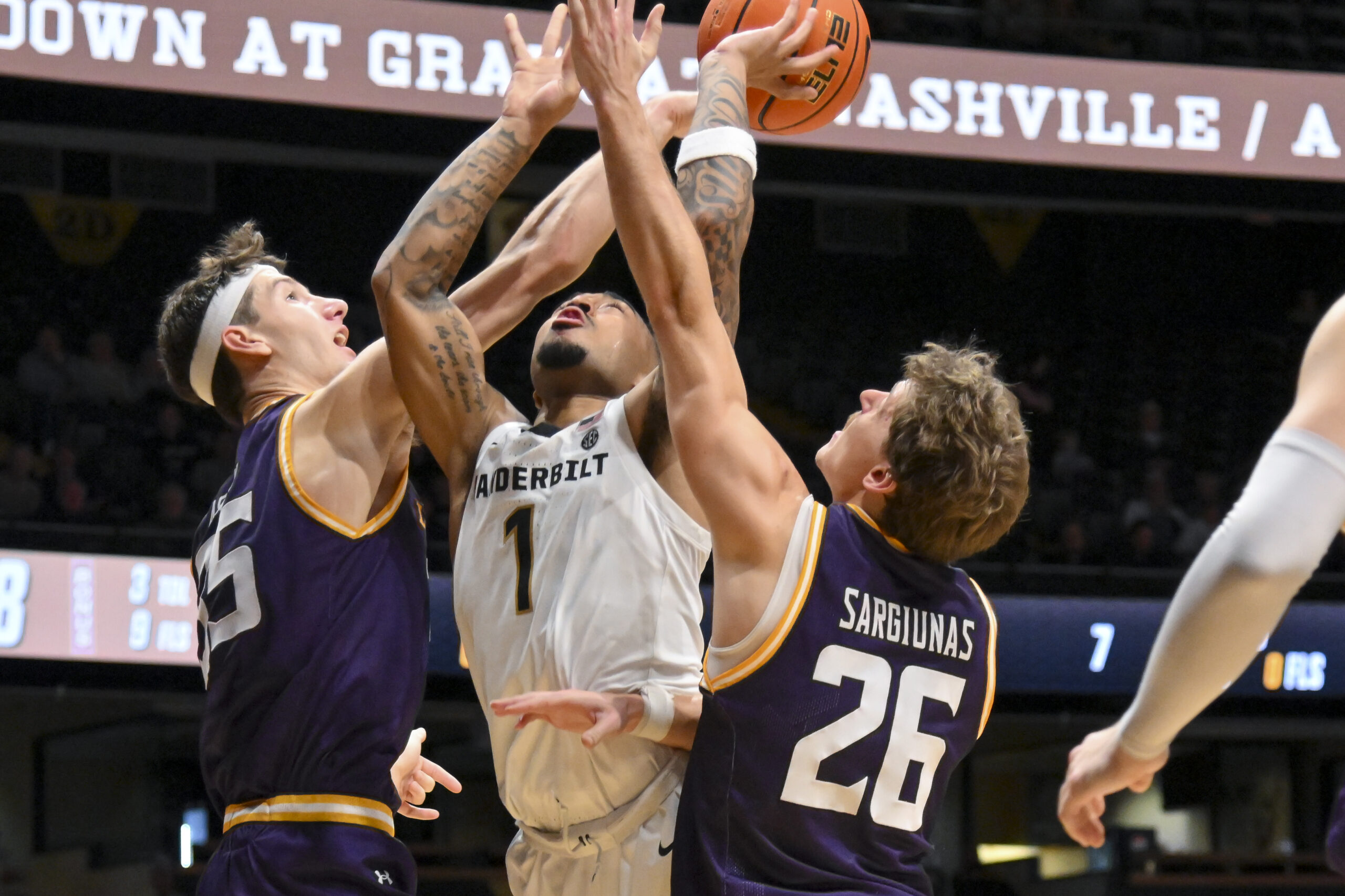 Nov 3, 2025; Nashville, Tennessee, USA; Lipscomb Bisons center Grant Asman (35) blocks the shot of Vanderbilt Commodores guard Frankie Collins (1) during the second half at Memorial Gymnasium. Mandatory Credit: Steve Roberts-Imagn Images