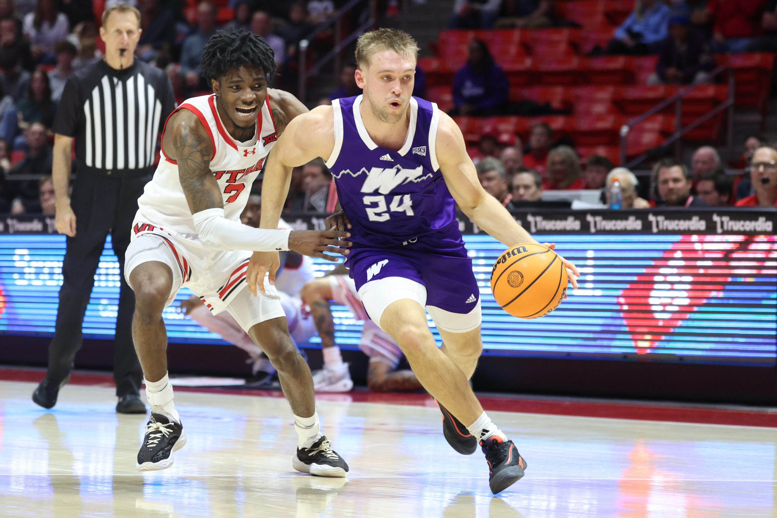 Nov 8, 2025; Salt Lake City, Utah, USA; Weber State Wildcats guard Jace Whiting (24) drives against Utah Utes guard Don McHenry (3) during the first half at Jon M. Huntsman Center. Mandatory Credit: Rob Gray-Imagn Images