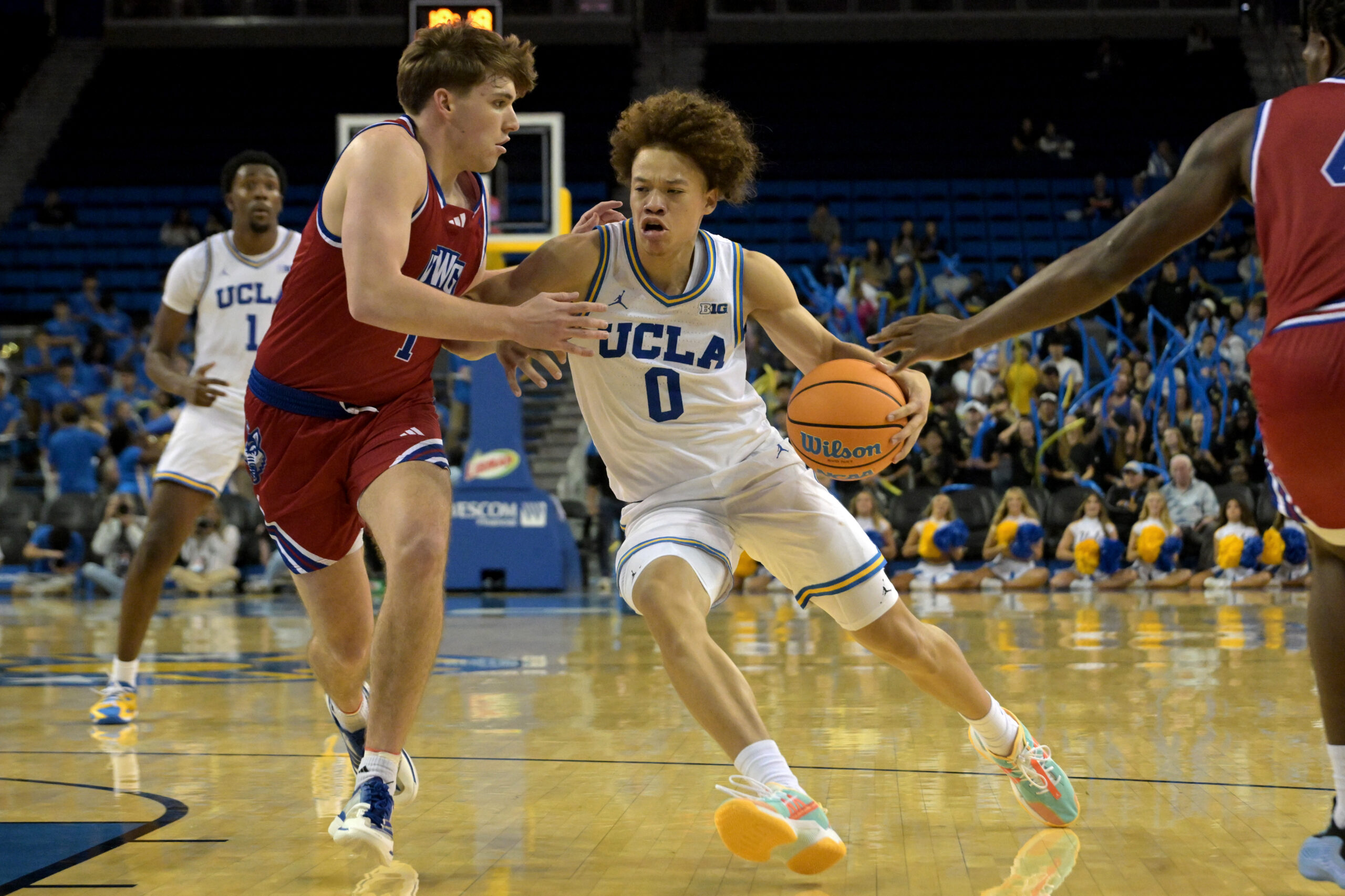 Nov 10, 2025; Los Angeles, California, USA; UCLA Bruins guard Trent Perry (0) is defended by West Georgia Wolves guard Brady Hardewig (1) during the second half at Pauley Pavilion presented by Wescom Financial. Mandatory Credit: Jayne Kamin-Oncea-Imagn Images