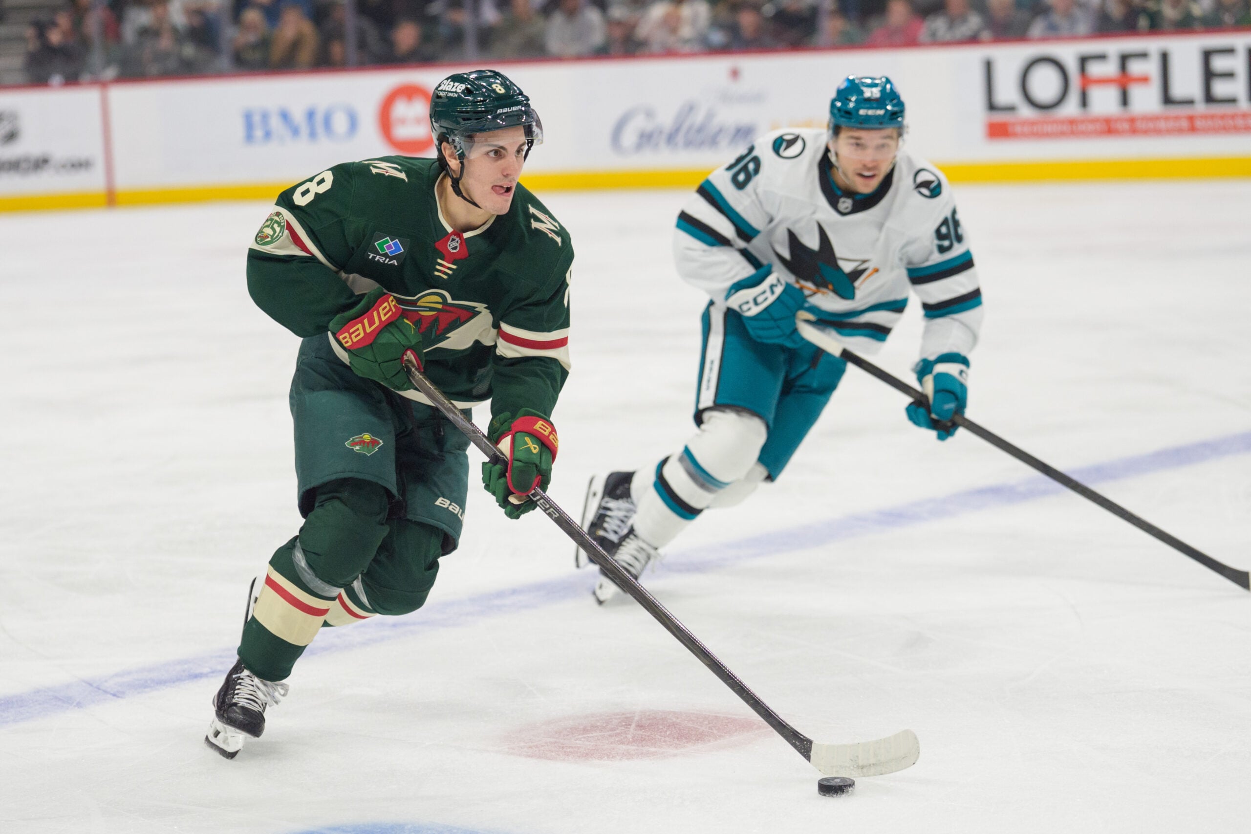 Nov 11, 2025; Saint Paul, Minnesota, USA; Minnesota Wild defenseman Zeev Buium (8) controls the puck defended by San Jose Sharks center Philipp Kurashev (96) in the first period at Grand Casino Arena. Mandatory Credit: Matt Blewett-Imagn Images