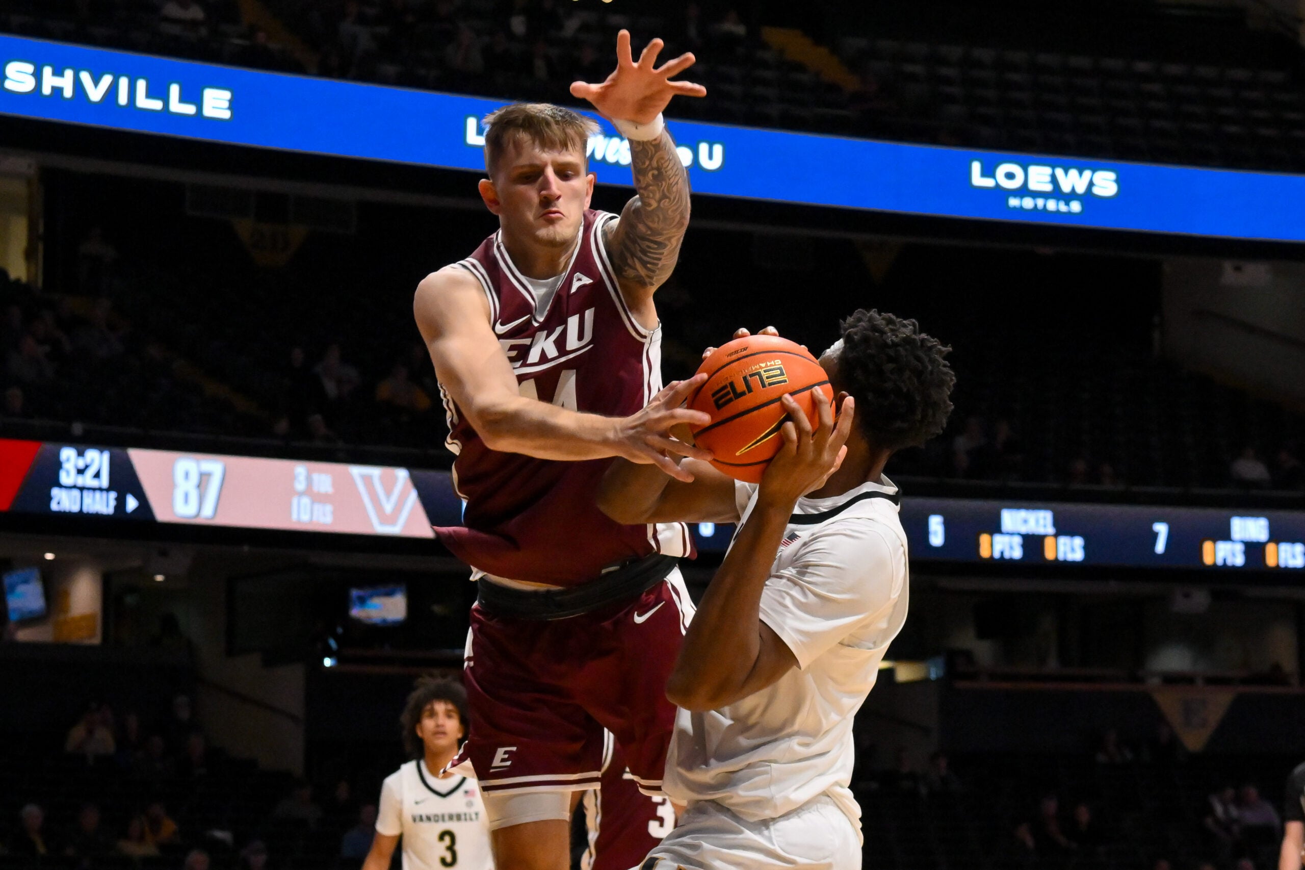 Nov 12, 2025; Nashville, Tennessee, USA;  Eastern Kentucky Colonels forward Austin Ball (14) blocks the shot of  Vanderbilt Commodores forward Ak Okereke (10) during the second half at Memorial Gymnasium. Mandatory Credit: Steve Roberts-Imagn Images