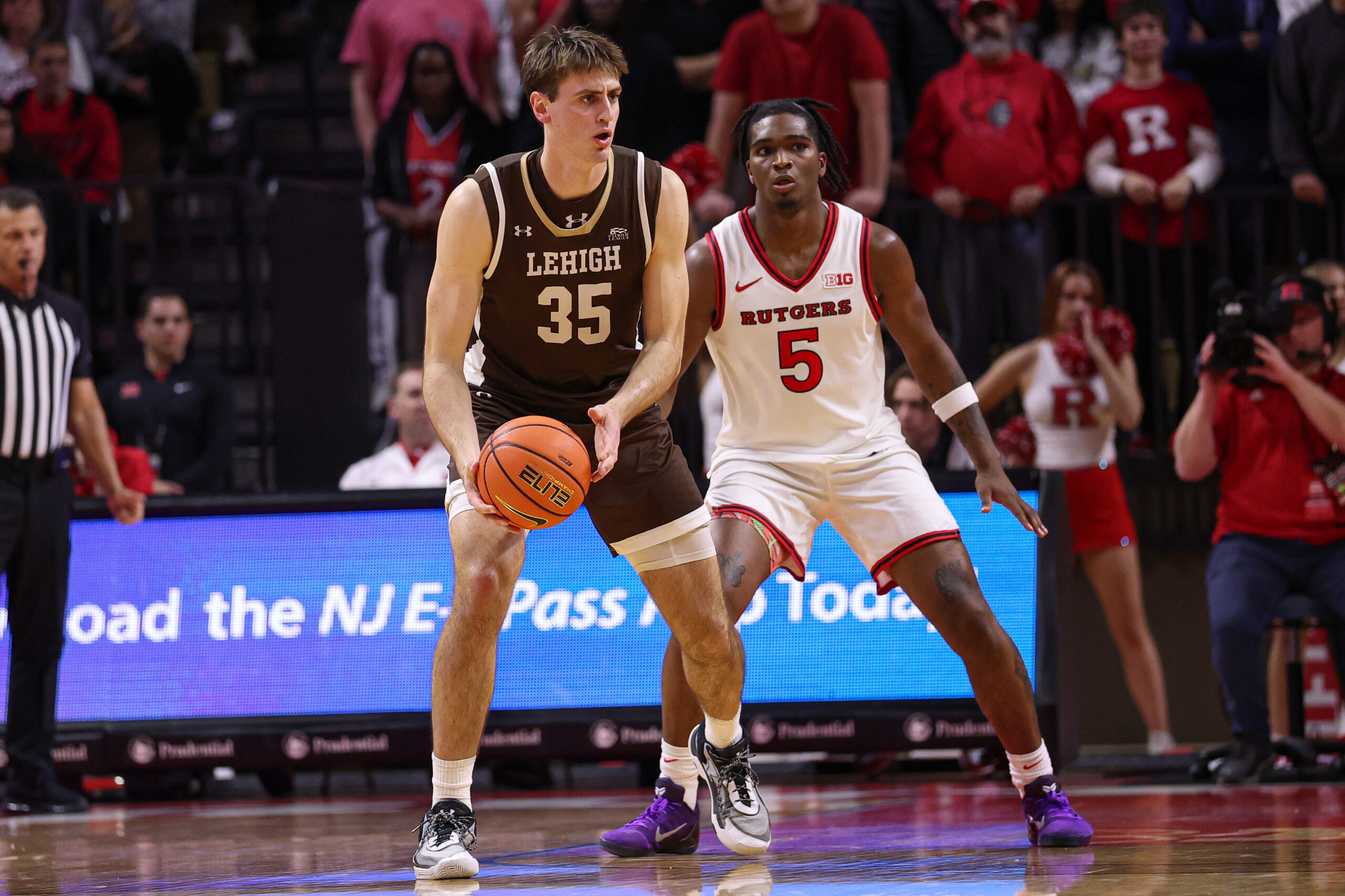 Nov 14, 2025; Piscataway, New Jersey, USA; Lehigh Mountain Hawks forward Hank Alvey (35) is guarded by Rutgers Scarlet Knights guard Darren Buchanan Jr. (5) during the second half at Jersey Mike's Arena. Mandatory Credit: Vincent Carchietta-Imagn Images