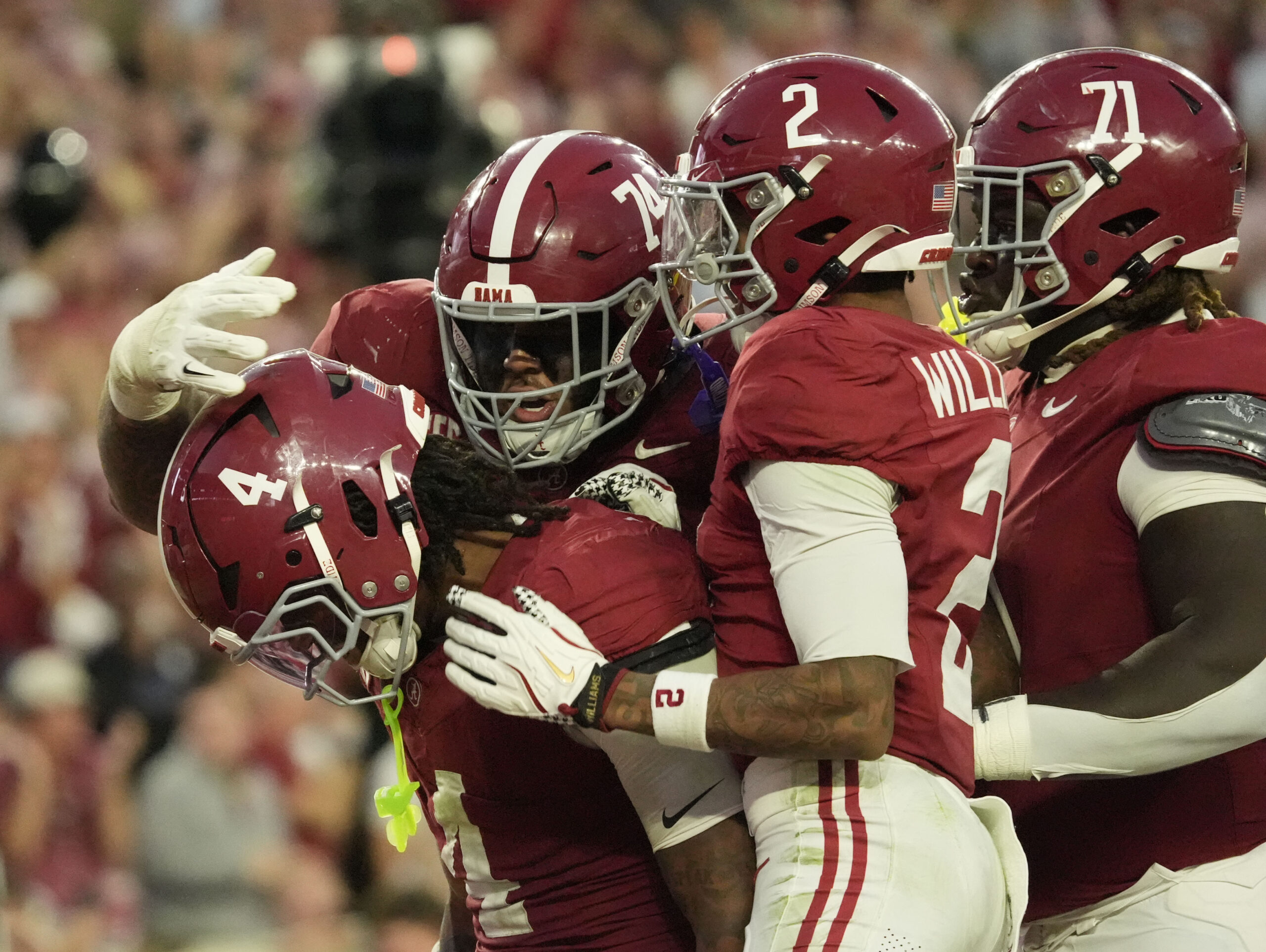 Nov 15, 2025; Tuscaloosa, Alabama, USA;  Alabama Crimson Tide running back Daniel Hill (4) celebrates his touchdown run against the Oklahoma Sooners with offensive lineman Kadyn Proctor (74), wide receiver Ryan Williams (2) and offensive lineman Kam Dewberry (71) at Saban Field at Bryant-Denny Stadium. Oklahoma defeated Alabama 23-21. Mandatory Credit: Gary Cosby Jr.-Imagn Images