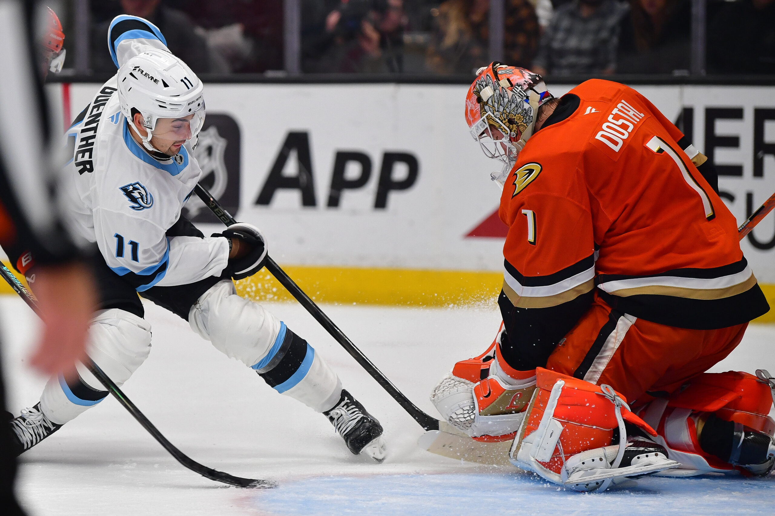 Nov 17, 2025; Anaheim, California, USA; Anaheim Ducks goaltender Lukas Dostal (1) blocks a shot against Utah Mammoth right wing Dylan Guenther (11) during the third period at Honda Center. Mandatory Credit: Gary A. Vasquez-Imagn Images