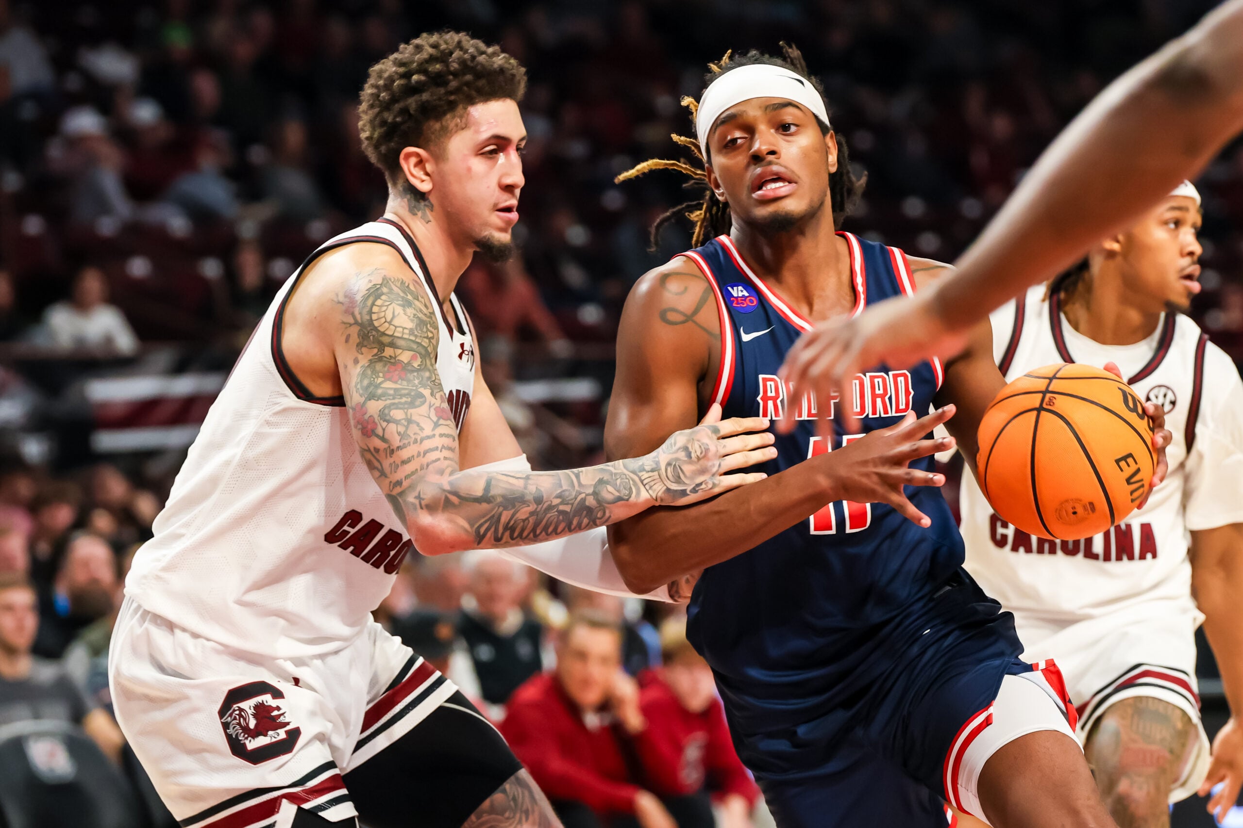 Nov 18, 2025; Columbia, South Carolina, USA; Radford Highlanders guard Dennis Parker (11) drives around South Carolina Gamecocks forward Myles Stute (10) in the second half at Colonial Life Arena. Mandatory Credit: Jeff Blake-Imagn Images