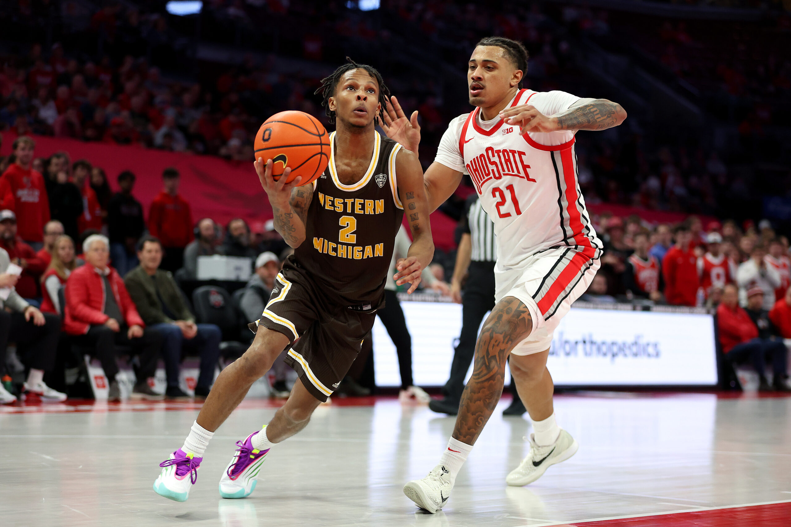 Nov 20, 2025; Columbus, Ohio, USA; Western Michigan Broncos guard Jalen Griffith (2) goes to the basket as Ohio State Buckeyes forward Devin Royal (21) defends during the first half at Value City Arena. Mandatory Credit: Joseph Maiorana-Imagn Images