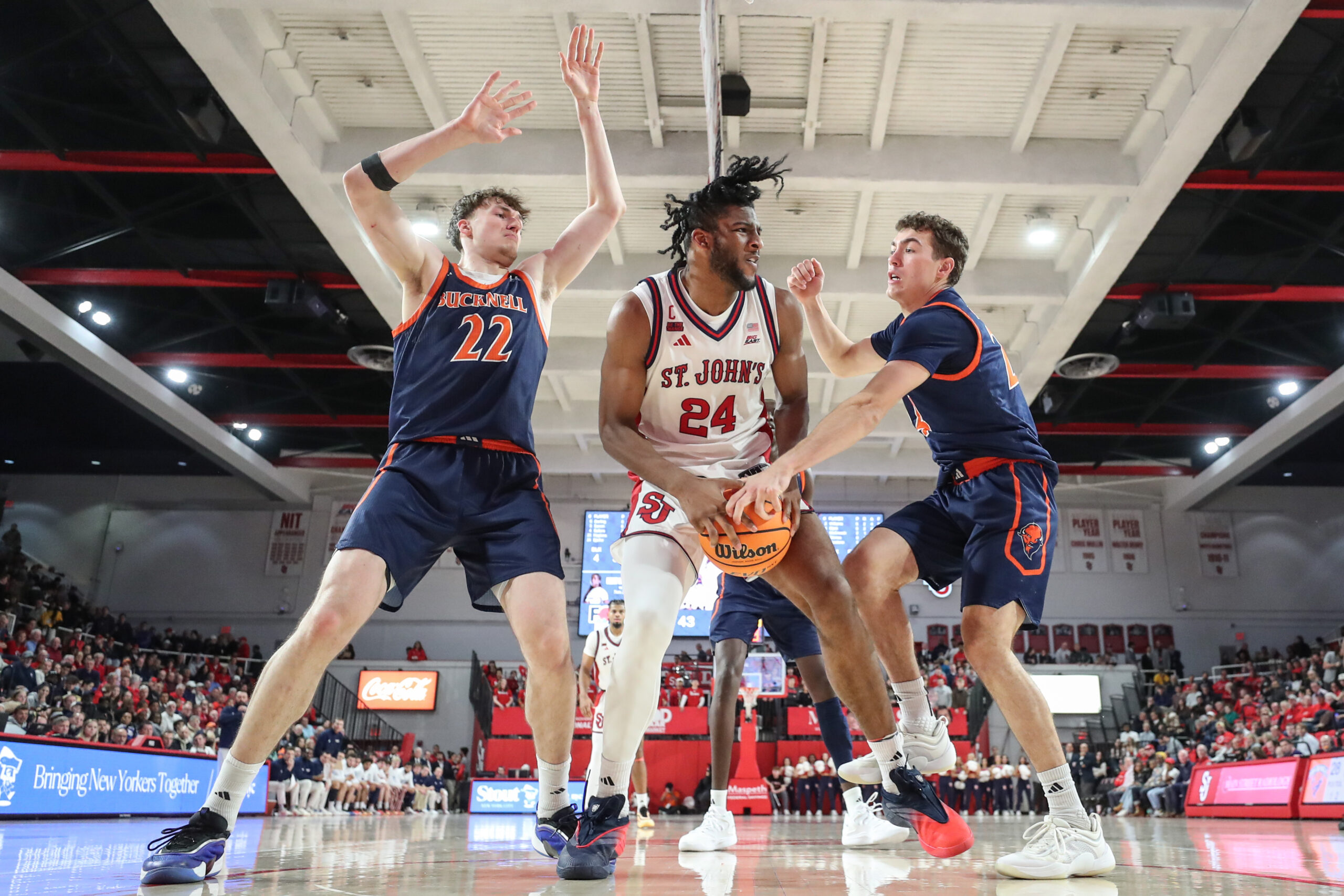 Nov 20, 2025; Queens, New York, USA; St. John's Red Storm forward Zuby Ejiofor (24) is double teammed by Bucknell Bison forward Amon Dörries (22) and guard Achile Spadone (24) in the second half at Carnesecca Arena. Mandatory Credit: Wendell Cruz-Imagn Images