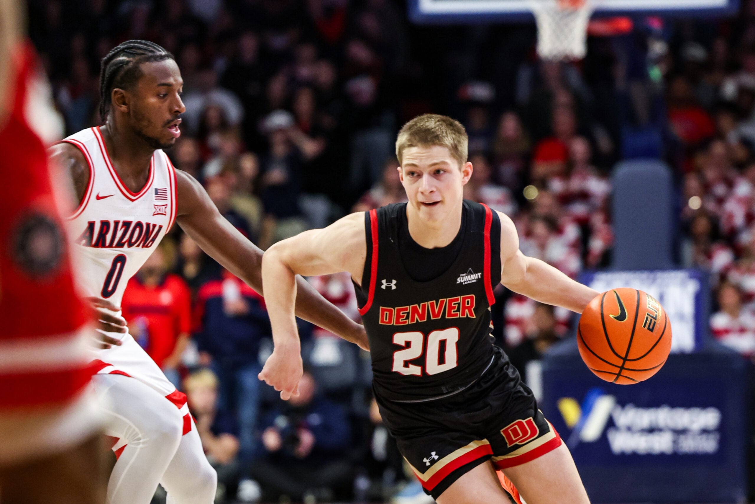Nov 24, 2025; Tucson, Arizona, USA; Denver Pioneers guard Carson Johnson (20) dribbles the ball during the first half of the game against the Arizona Wildcats at McKale Memorial Center. Mandatory Credit: Aryanna Frank-Imagn Images