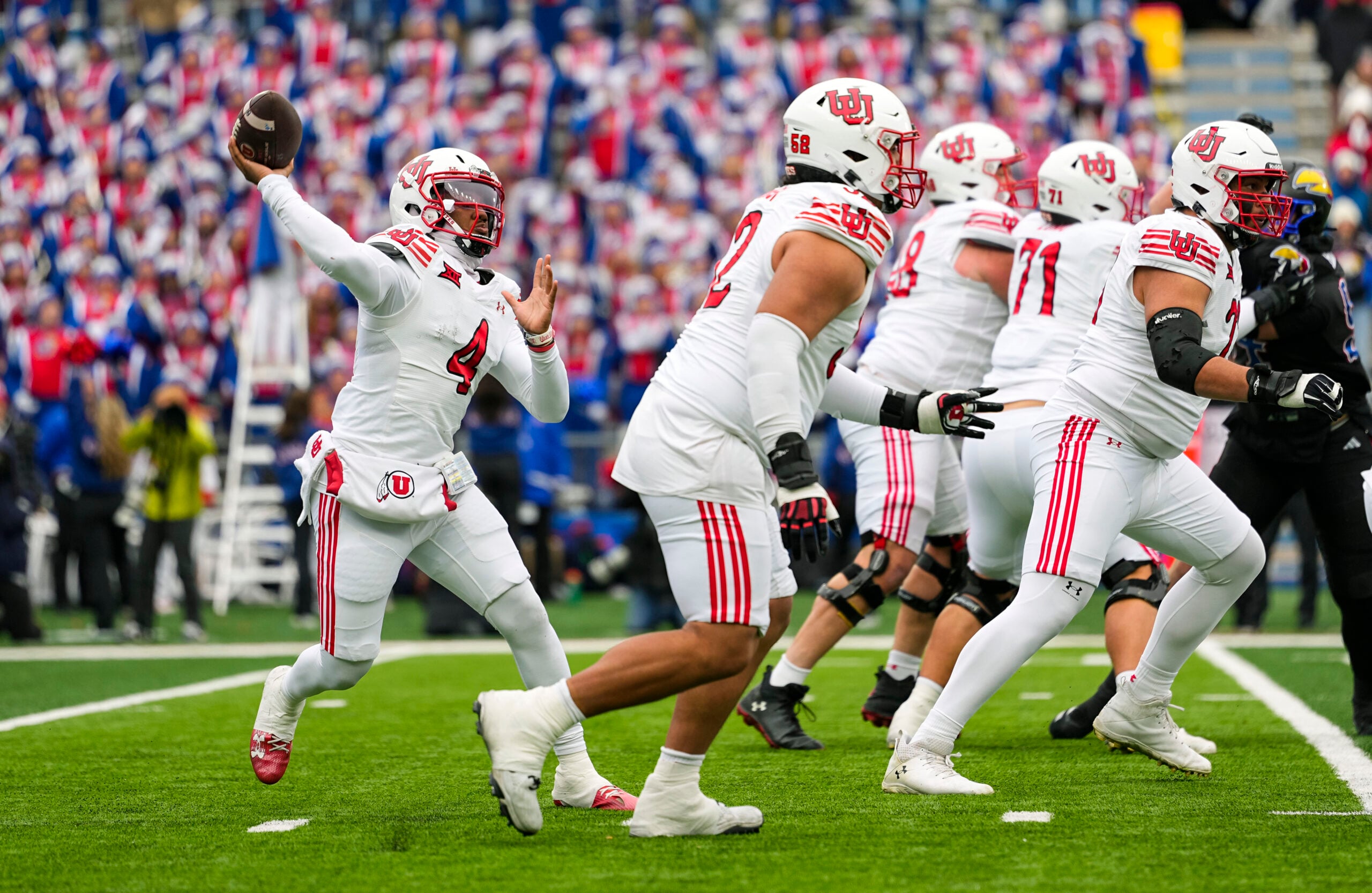 Nov 28, 2025; Lawrence, Kansas, USA; Utah Utes quarterback Devon Dampier (4) throws a pass during the first half against the Kansas Jayhawks at David Booth Kansas Memorial Stadium. Mandatory Credit: Jay Biggerstaff-Imagn Images