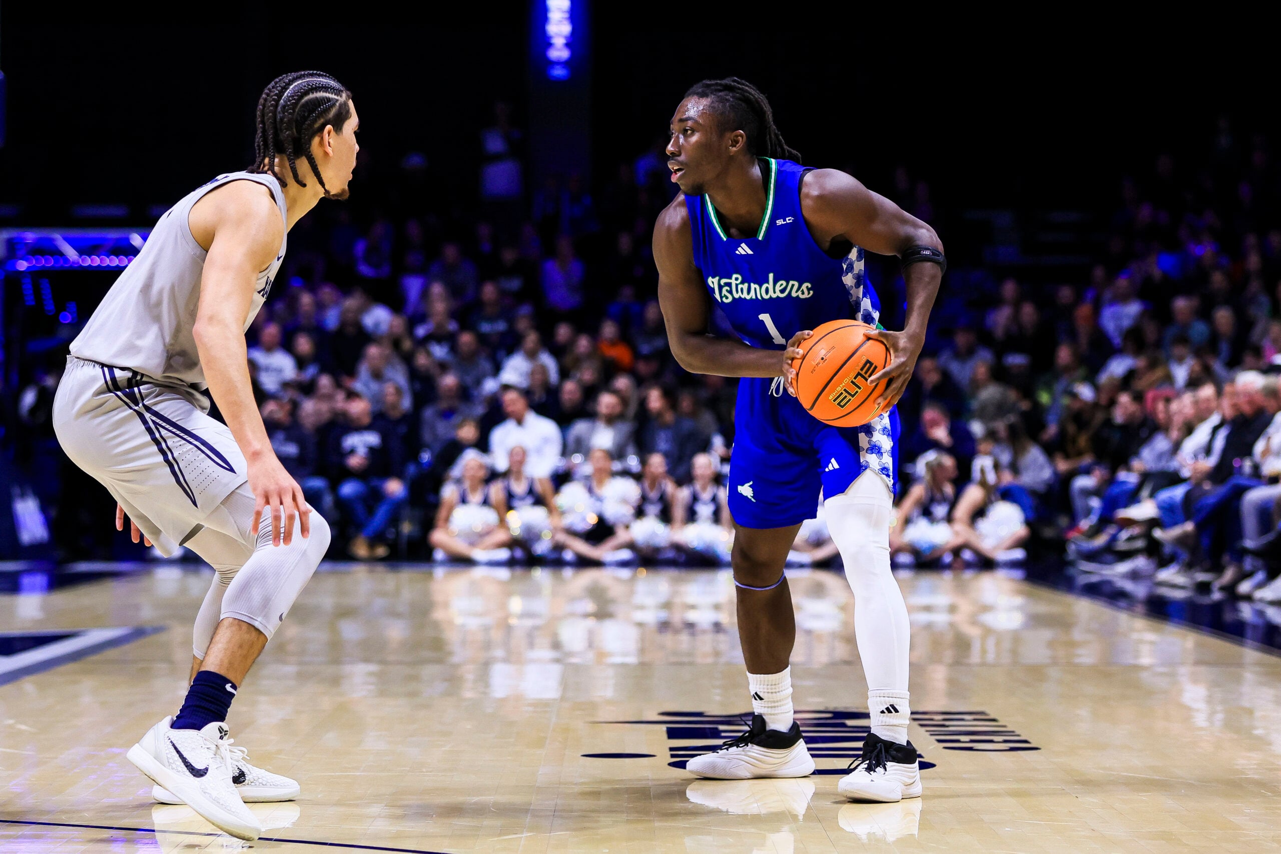 Nov 28, 2025; Cincinnati, Ohio, USA; Texas A&M-Corpus Christi Islanders guard Nick Shogbonyo (1) holds the ball against Xavier Musketeers guard Malik Messina-Moore (1) in the first half at Cintas Center. Mandatory Credit: Katie Stratman-Imagn Images