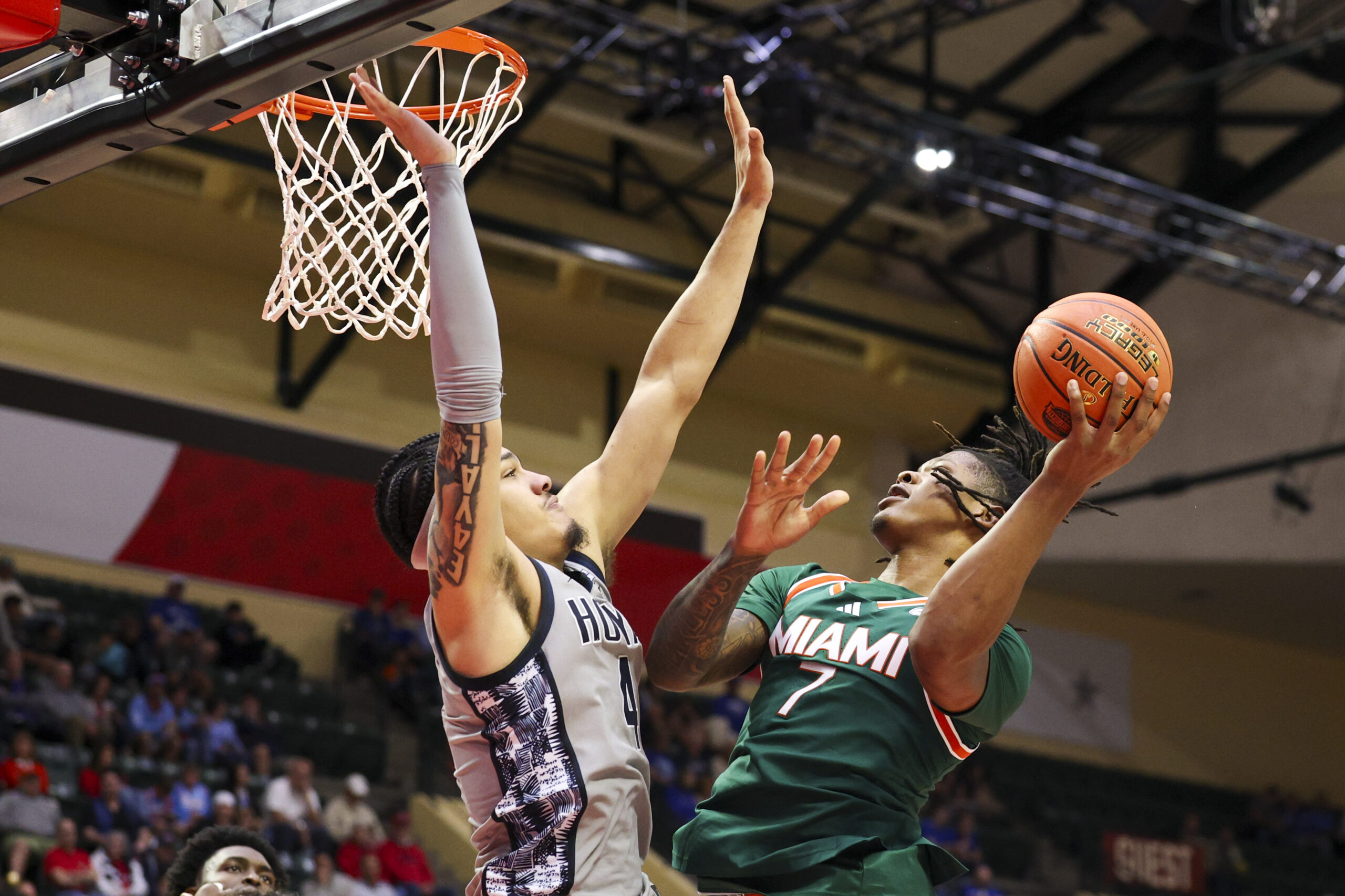 Nov 28, 2025; Kissimmee, FL, USA; Miami (FL) Hurricanes forward Shelton Henderson (7) shoots the ball over Georgetown Hoyas forward Caleb Williams (4) in the second half during the ESPN Events Invitational at State Farm Field House. Mandatory Credit: Nathan Ray Seebeck-Imagn Images