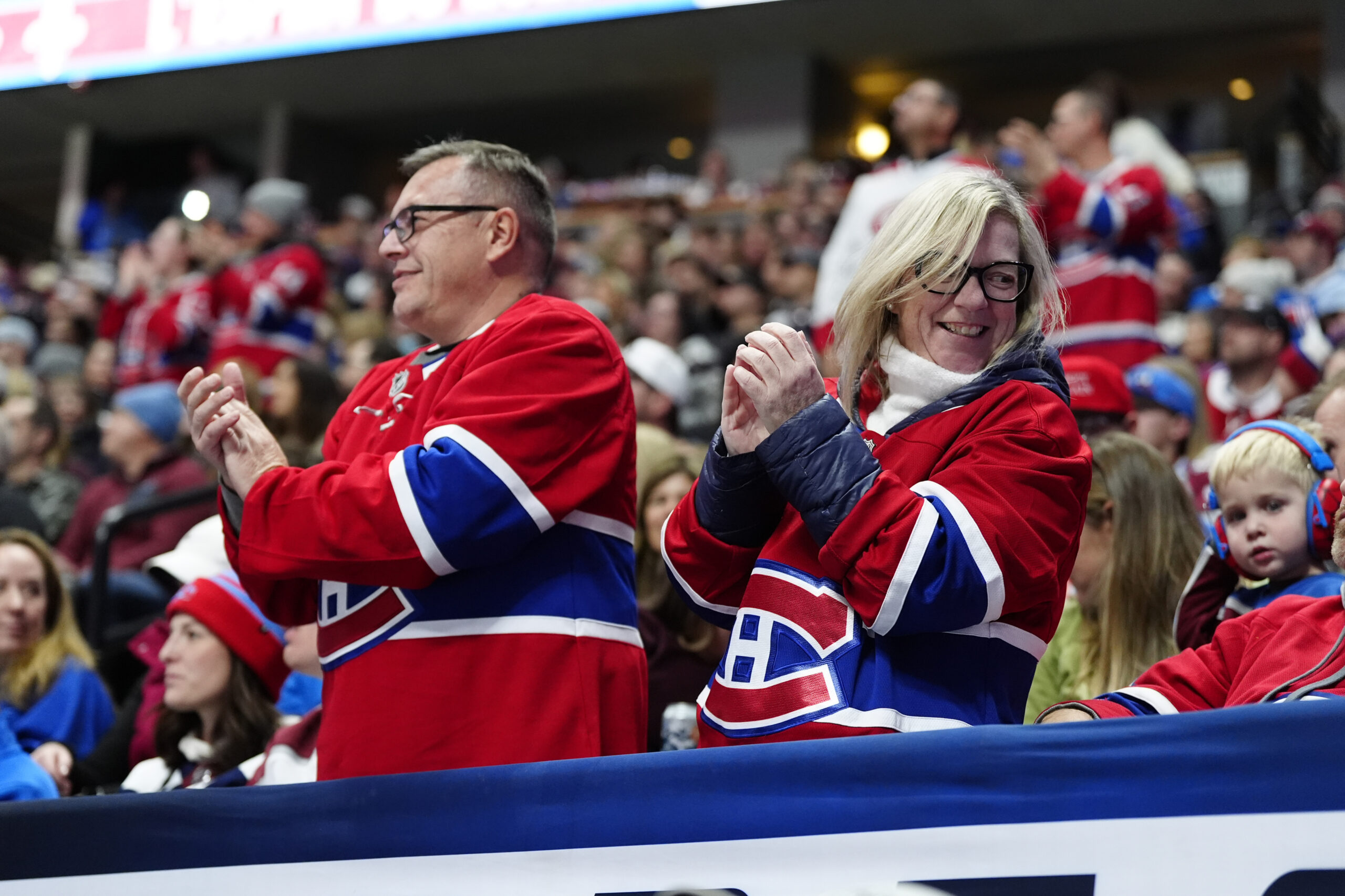Nov 29, 2025; Denver, Colorado, USA; Montreal Canadiens fans celebrate a goal scored in the third period against the Montreal Canadiens at Ball Arena. Mandatory Credit: Ron Chenoy-Imagn Images
