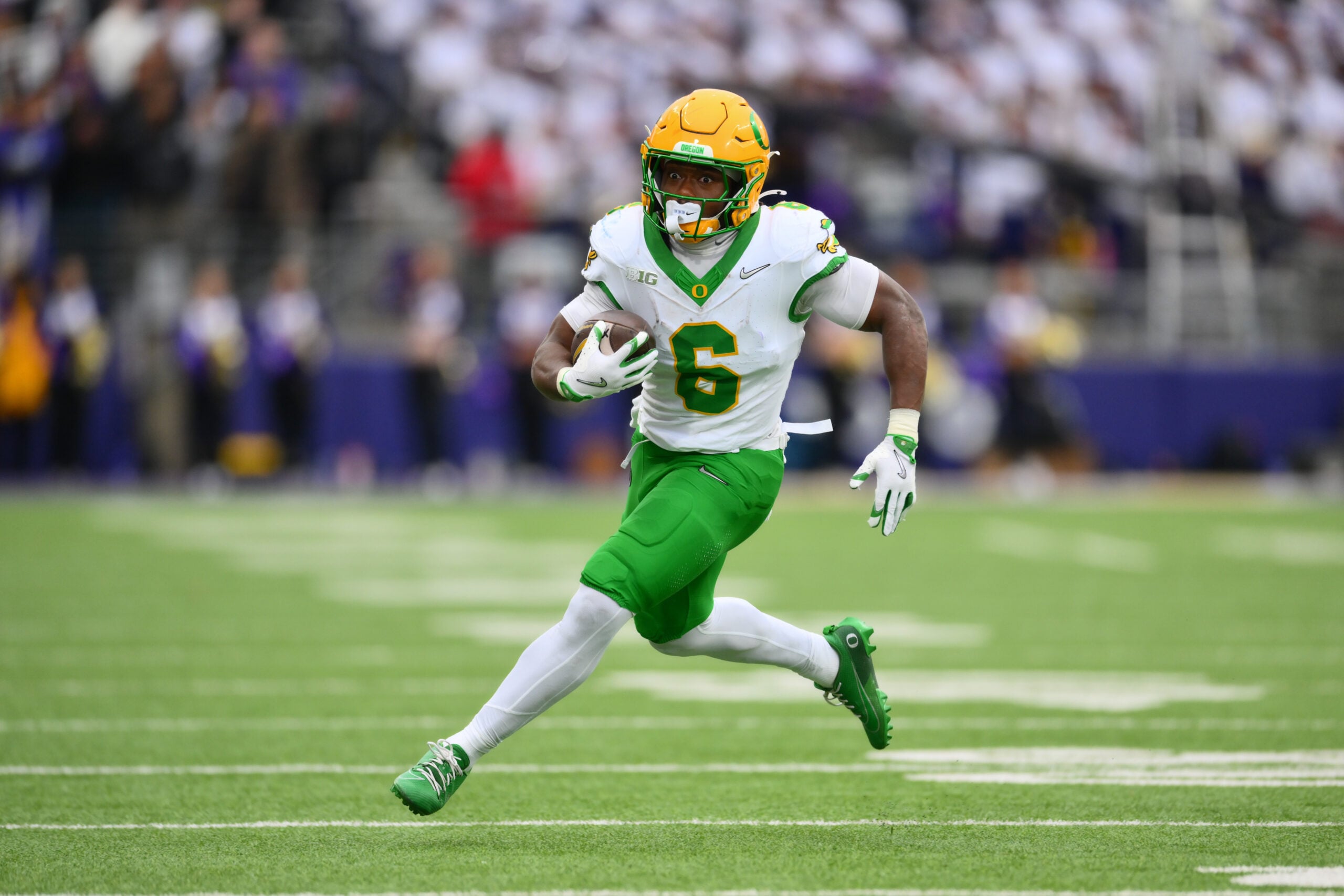 Nov 29, 2025; Seattle, Washington, USA; Oregon Ducks running back Noah Whittington (6) carries the ball against the Washington Huskies during the first half at Husky Stadium. Mandatory Credit: Steven Bisig-Imagn Images