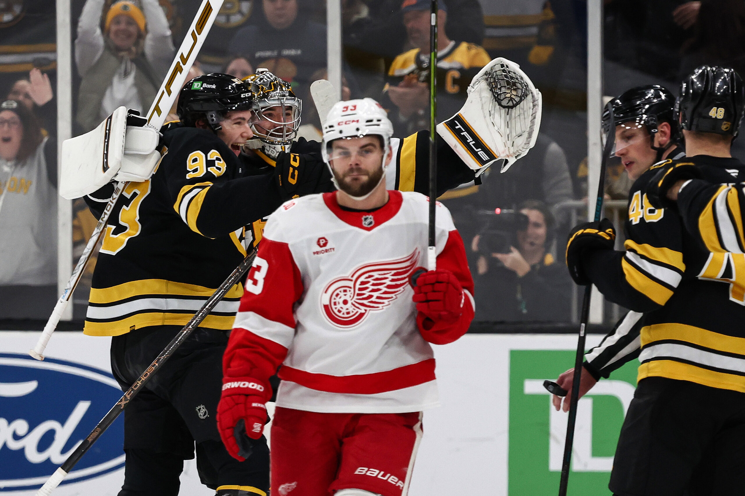 Nov 29, 2025; Boston, Massachusetts, USA; Detroit Red Wings right wing Alex Debrincat (93) skates away after being stopped on Detroit’s last shootout attempt by Boston Bruins goaltender Jeremy Swayman (1) who celebrates with center Fraser Minten (93) at TD Garden. Mandatory Credit: Winslow Townson-Imagn Images