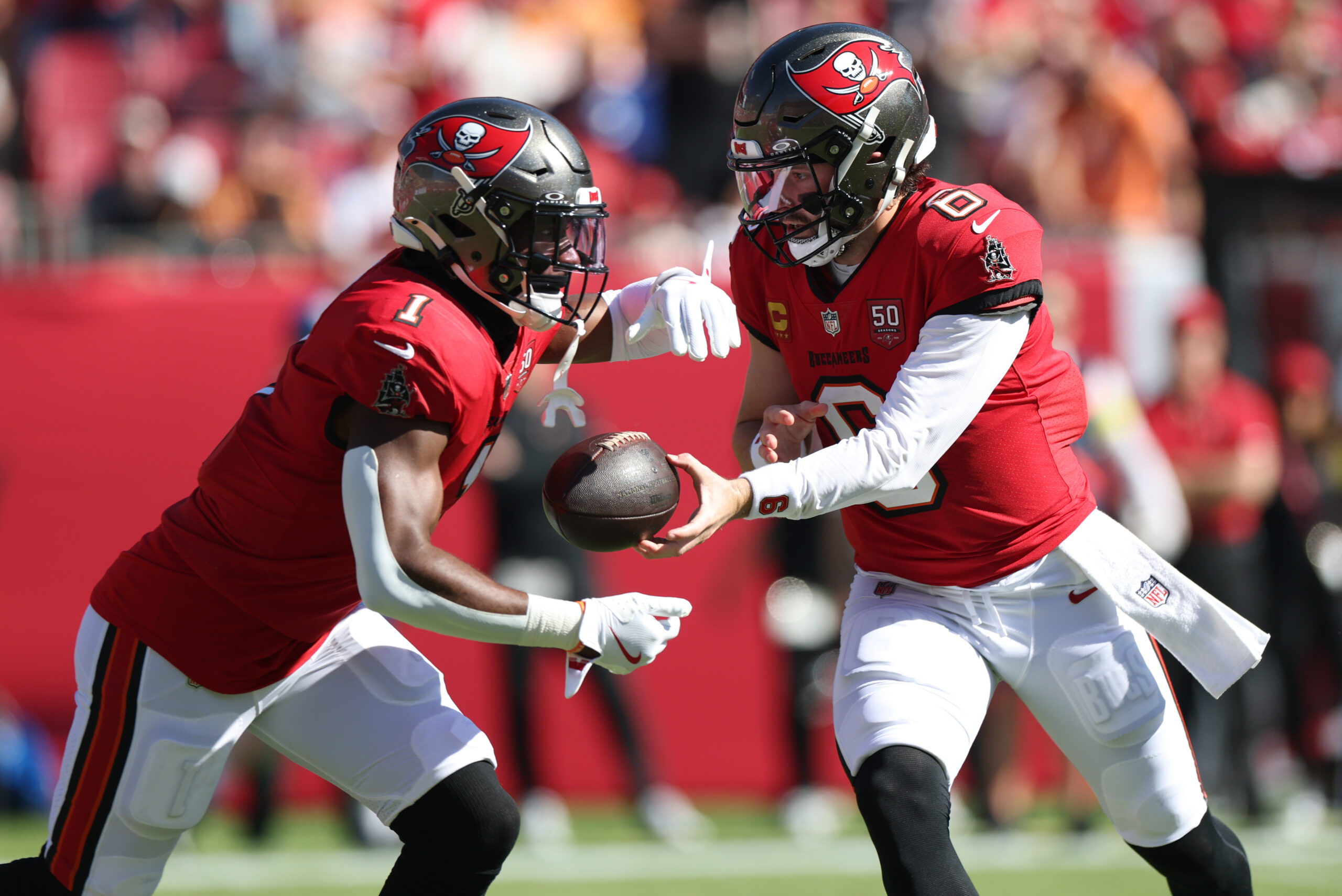 Nov 30, 2025; Tampa, Florida, USA; Tampa Bay Buccaneers quarterback Baker Mayfield (6) hands off to running back Rachaad White (1) during the first half against the Arizona Cardinals at Raymond James Stadium. Mandatory Credit: Nathan Ray Seebeck-Imagn Images