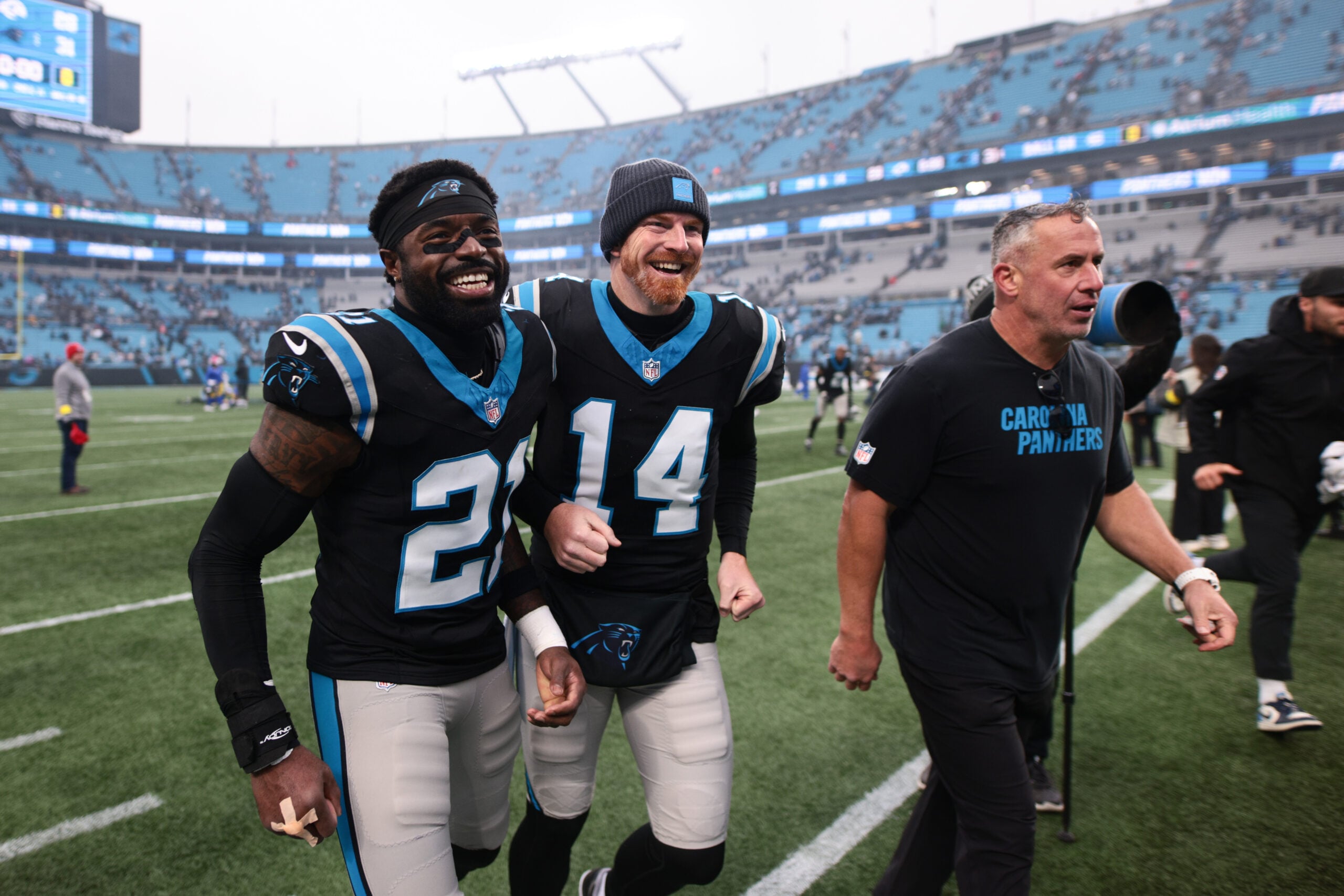 Nov 30, 2025; Charlotte, North Carolina, USA; Carolina Panthers safety Nick Scott (21) and Carolina Panthers quarterback Andy Dalton (14) celebrate after the game against the Los Angeles Rams at Bank of America Stadium. Mandatory Credit: Scott Kinser-Imagn Images