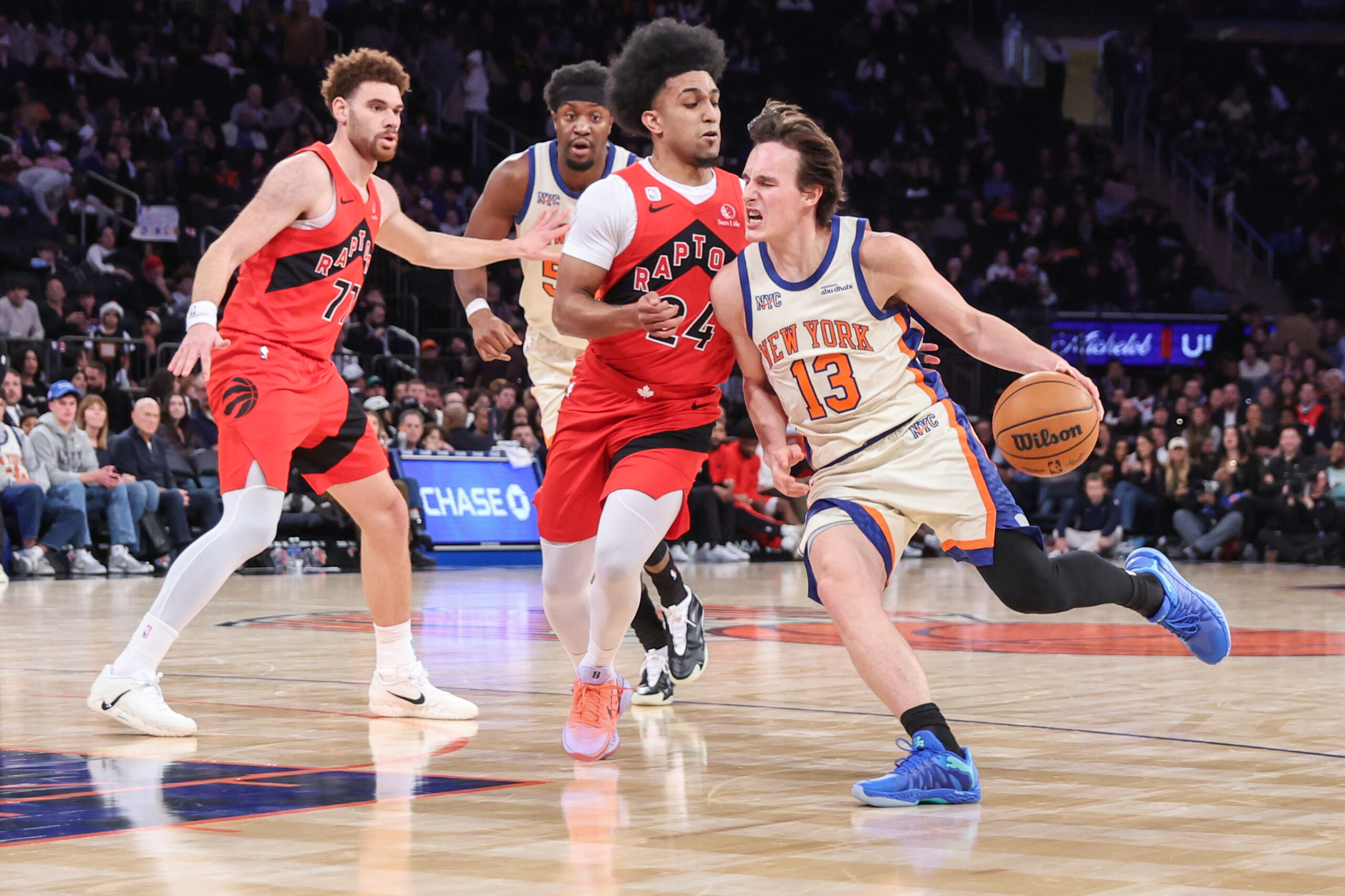 Nov 30, 2025; New York, New York, USA;  New York Knicks guard Tyler Kolek (13) drives past Toronto Raptors guard Chucky Hepburn (24) in the fourth quarter at Madison Square Garden. Mandatory Credit: Wendell Cruz-Imagn Images
