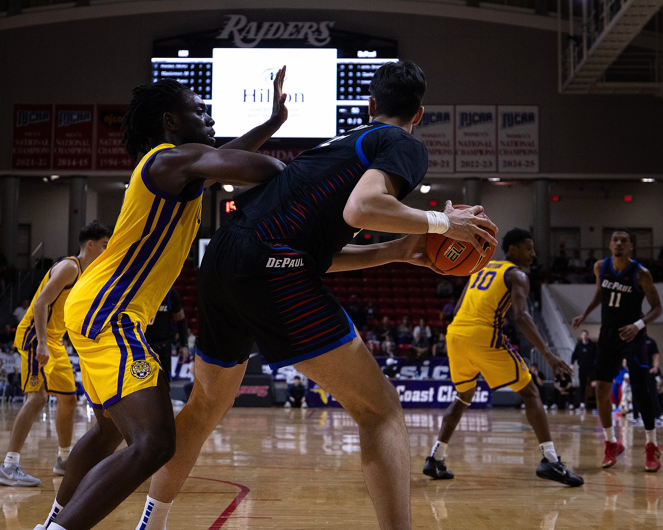 LSU's Mike Nwoko (1) defends DePaul's Fabián Flores (15) during the Emerald Coast Classic championship at Raider Arena in Niceville, Fla., Nov. 29, 2025. The Tigers won the contest 96-63. (Tyler Orsburn/News Herald)