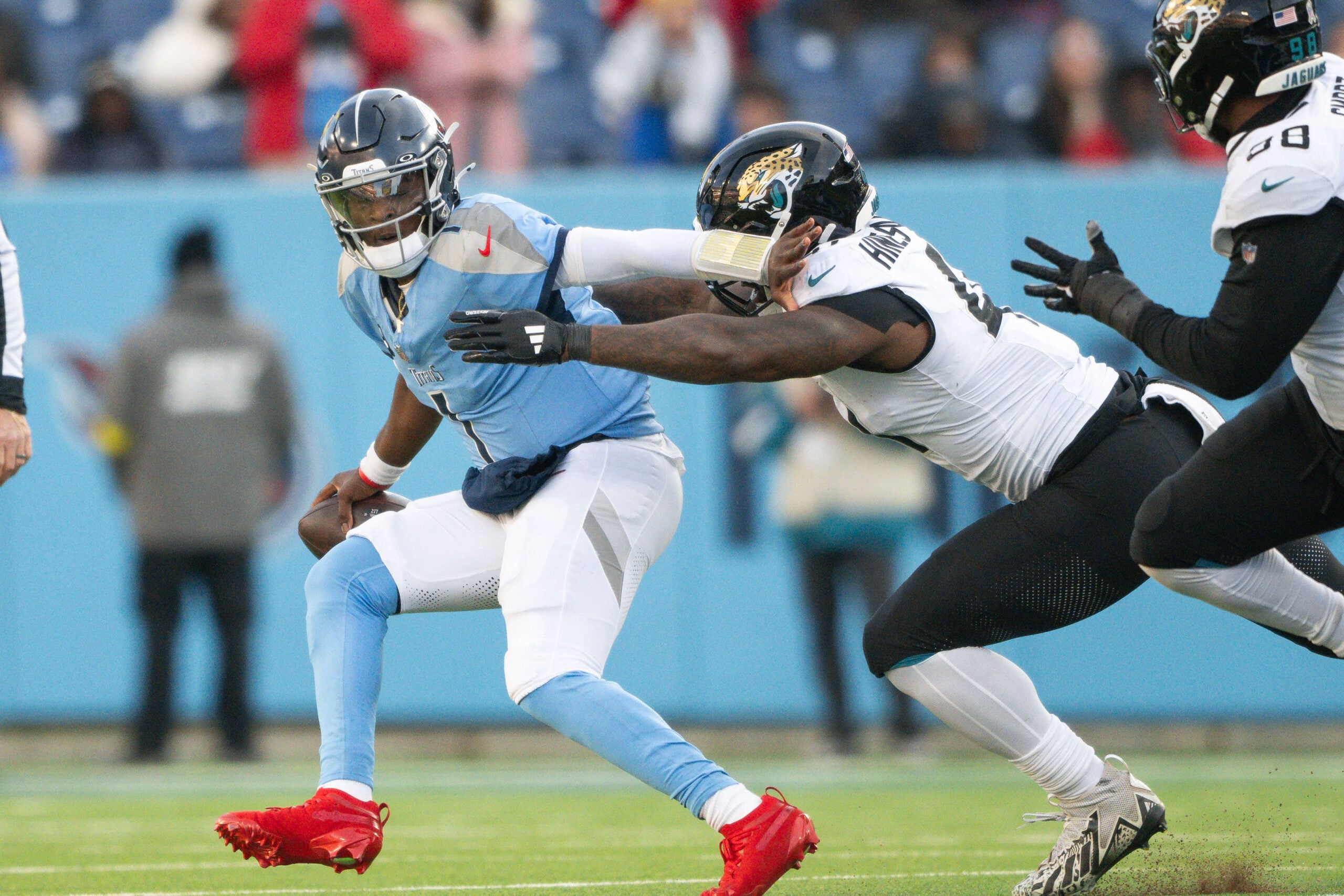 Nov 30, 2025; Nashville, Tennessee, USA; Jacksonville Jaguars defensive end Josh Hines-Allen (41) sacks Tennessee Titans quarterback Cameron Ward (1) during the second half at Nissan Stadium. Mandatory Credit: Steve Roberts-Imagn Images
