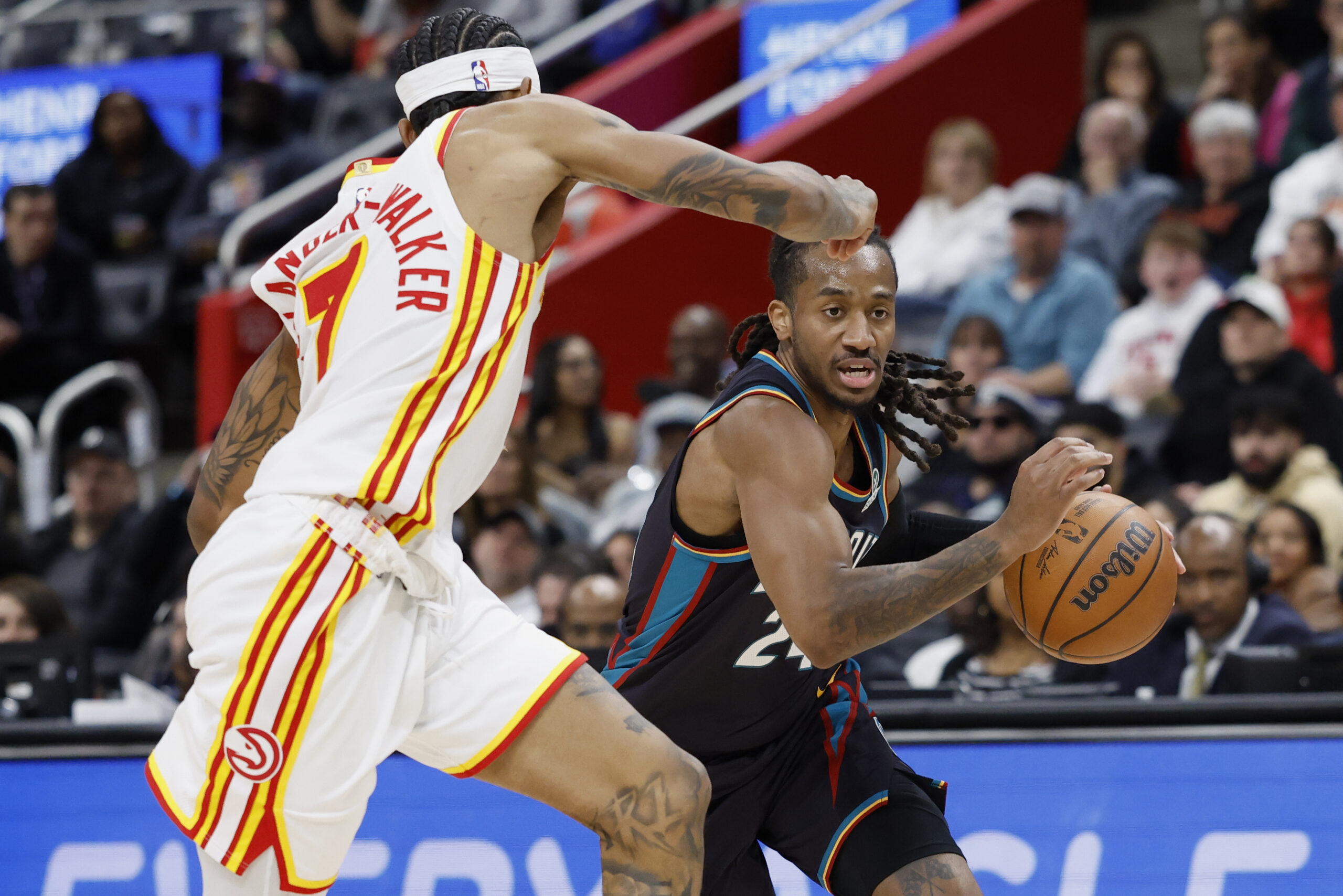 Dec 1, 2025; Detroit, Michigan, USA;  Detroit Pistons guard Daniss Jenkins (24) dribbles defended by Atlanta Hawks guard Nickeil Alexander-Walker (7) in the second half at Little Caesars Arena. Mandatory Credit: Rick Osentoski-Imagn Images