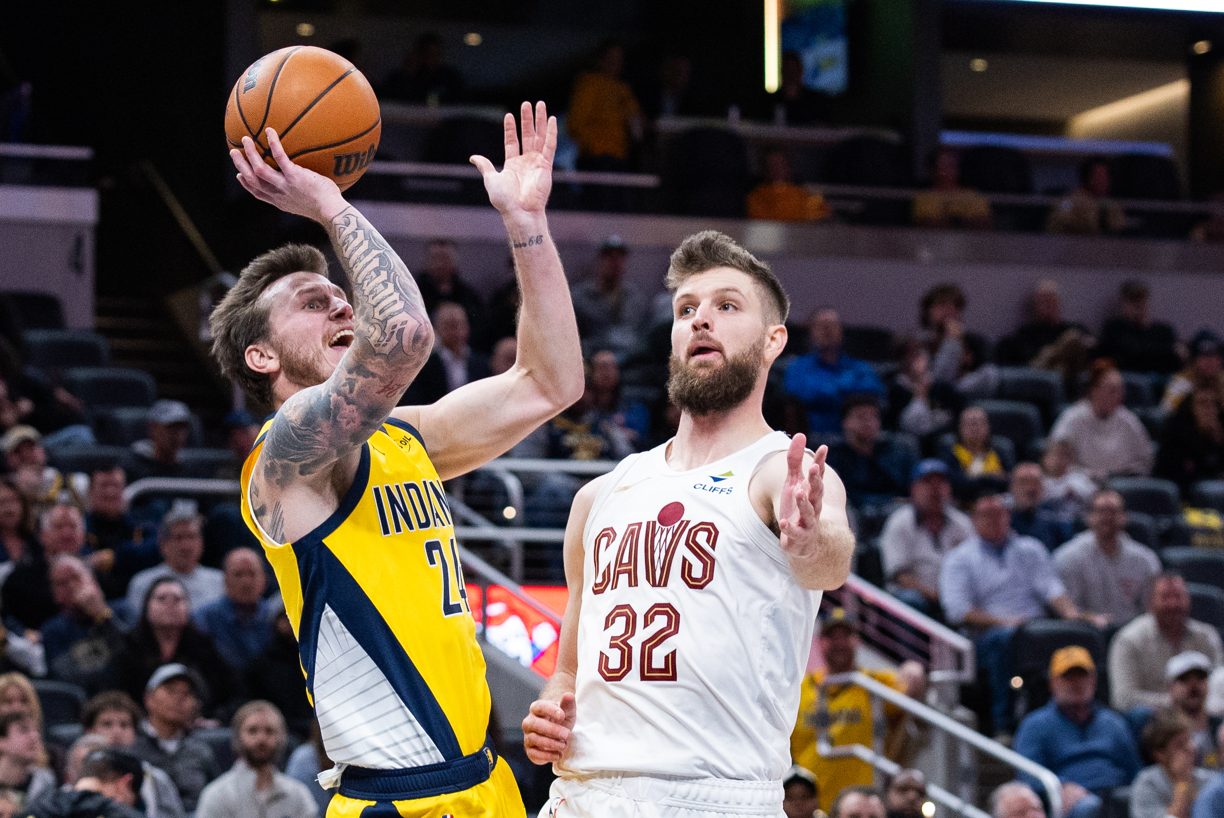 Dec 1, 2025; Indianapolis, Indiana, USA; Indiana Pacers guard Garrison Mathews (24) shoots the ball while Cleveland Cavaliers forward Dean Wade (32) defends in the second half at Gainbridge Fieldhouse. Mandatory Credit: Trevor Ruszkowski-Imagn Images