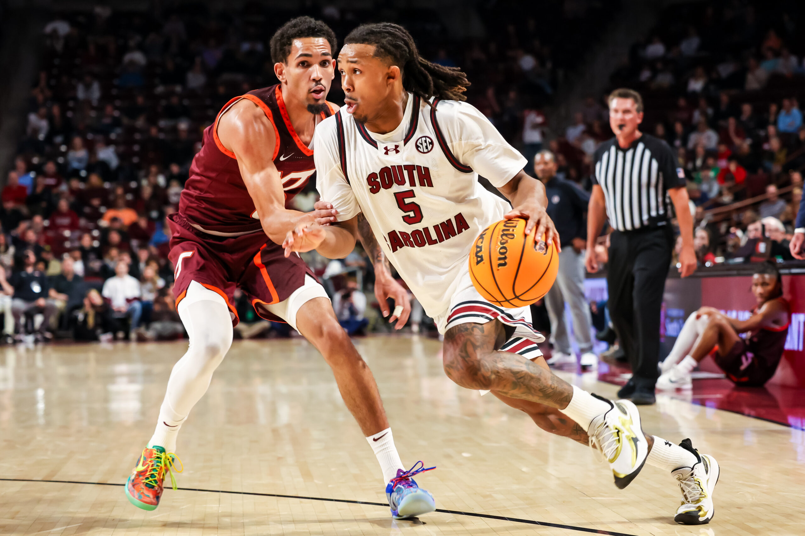 Dec 2, 2025; Columbia, South Carolina, USA; South Carolina Gamecocks guard Meechie Johnson (5) drives past Virginia Tech Hokies guard Jailen Bedford (0) in the first half at Colonial Life Arena. Mandatory Credit: Jeff Blake-Imagn Images