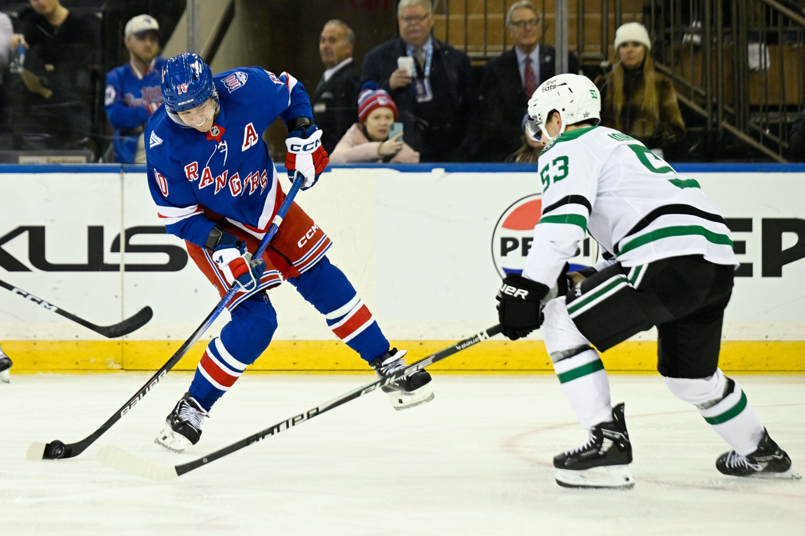 Dec 2, 2025; New York, New York, USA; New York Rangers left wing Artemi Panarin (10) attempts a shot defend by Dallas Stars center Wyatt Johnston (53) during the third period at Madison Square Garden. Mandatory Credit: Dennis Schneidler-Imagn Images