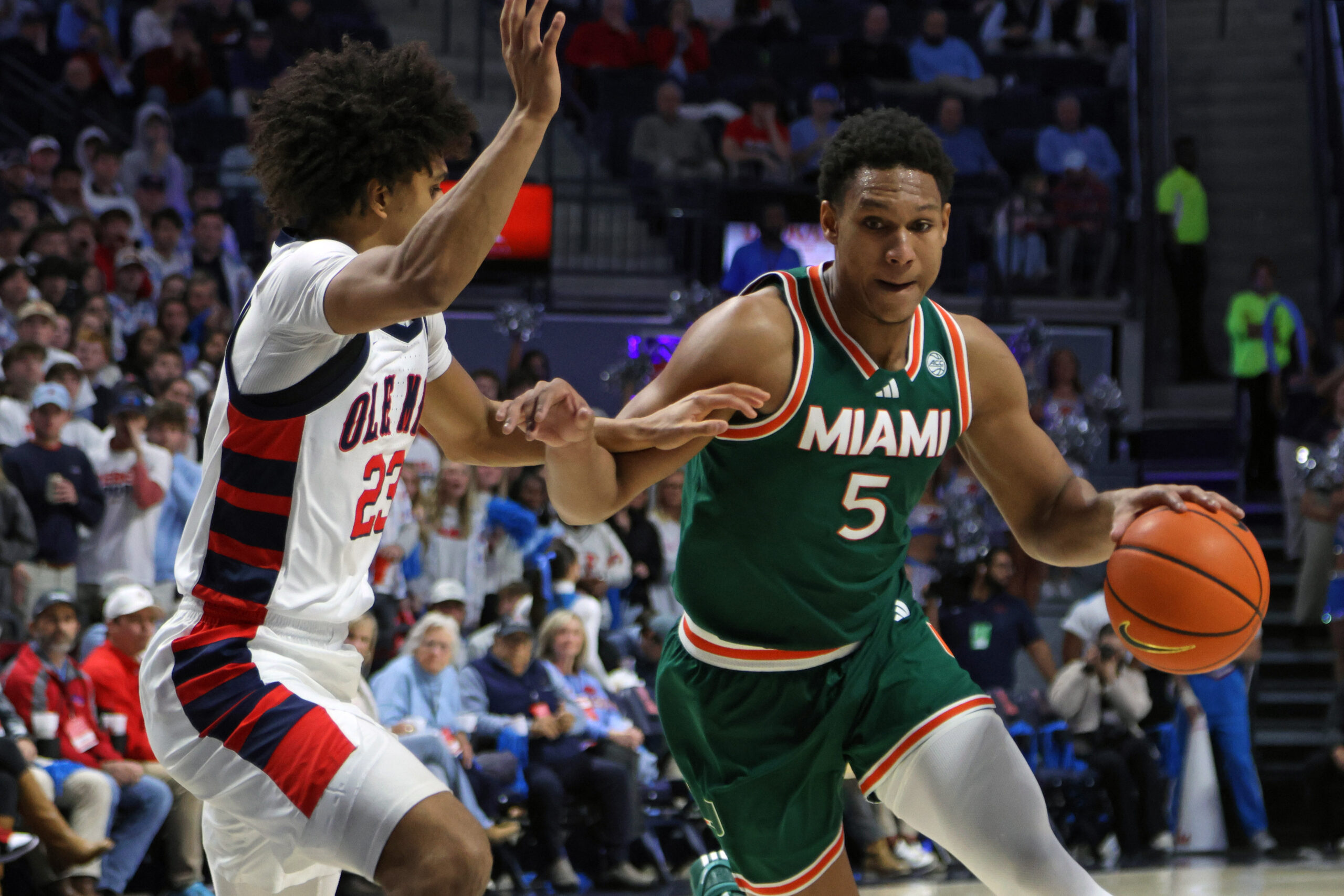 Dec 2, 2025; Oxford, Mississippi, USA; Miami Hurricanes forward Malik Reneau (5) drives to the basket as Mississippi Rebels guard Patton Pinkins (23) defends during the first half at The Sandy and John Black Pavilion at Ole Miss. Mandatory Credit: Petre Thomas-Imagn Images