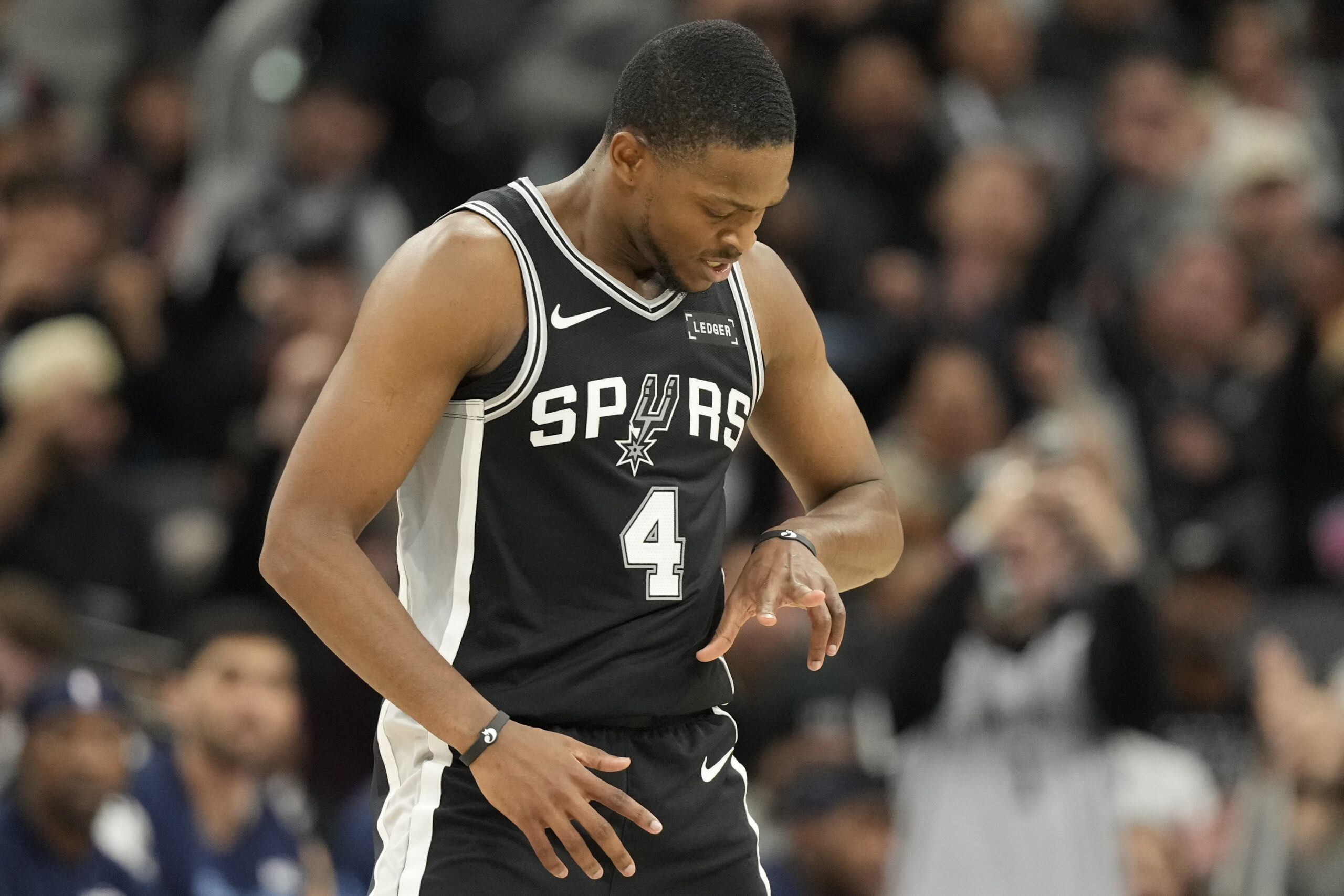 Dec 2, 2025; San Antonio, Texas, USA; San Antonio Spurs guard De’Aaron Fox (4) reacts after scoring a three point basket during the second half against the Memphis Grizzlies at Frost Bank Center. Mandatory Credit: Scott Wachter-Imagn Images