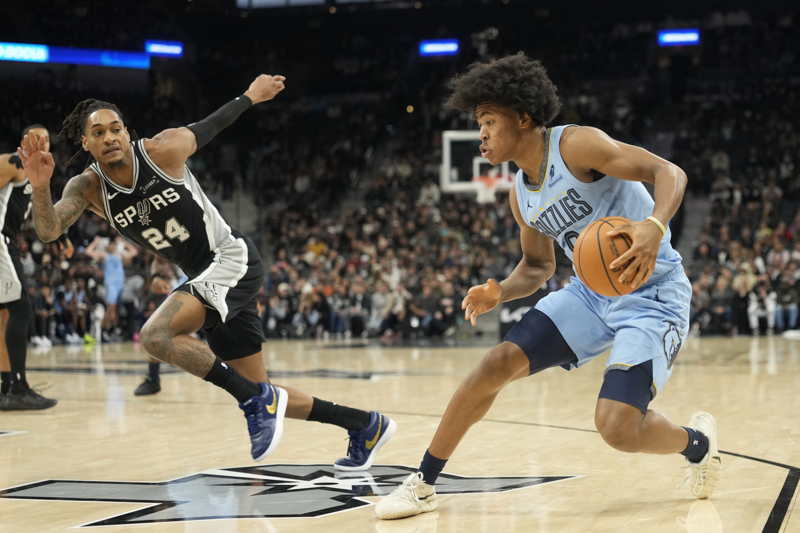 Dec 2, 2025; San Antonio, Texas, USA; Memphis Grizzlies guard Jaylen Wells (0)drives to the basket against San Antonio Spurs guard Devin Vassell (24) during the second half at Frost Bank Center. Mandatory Credit: Scott Wachter-Imagn Images