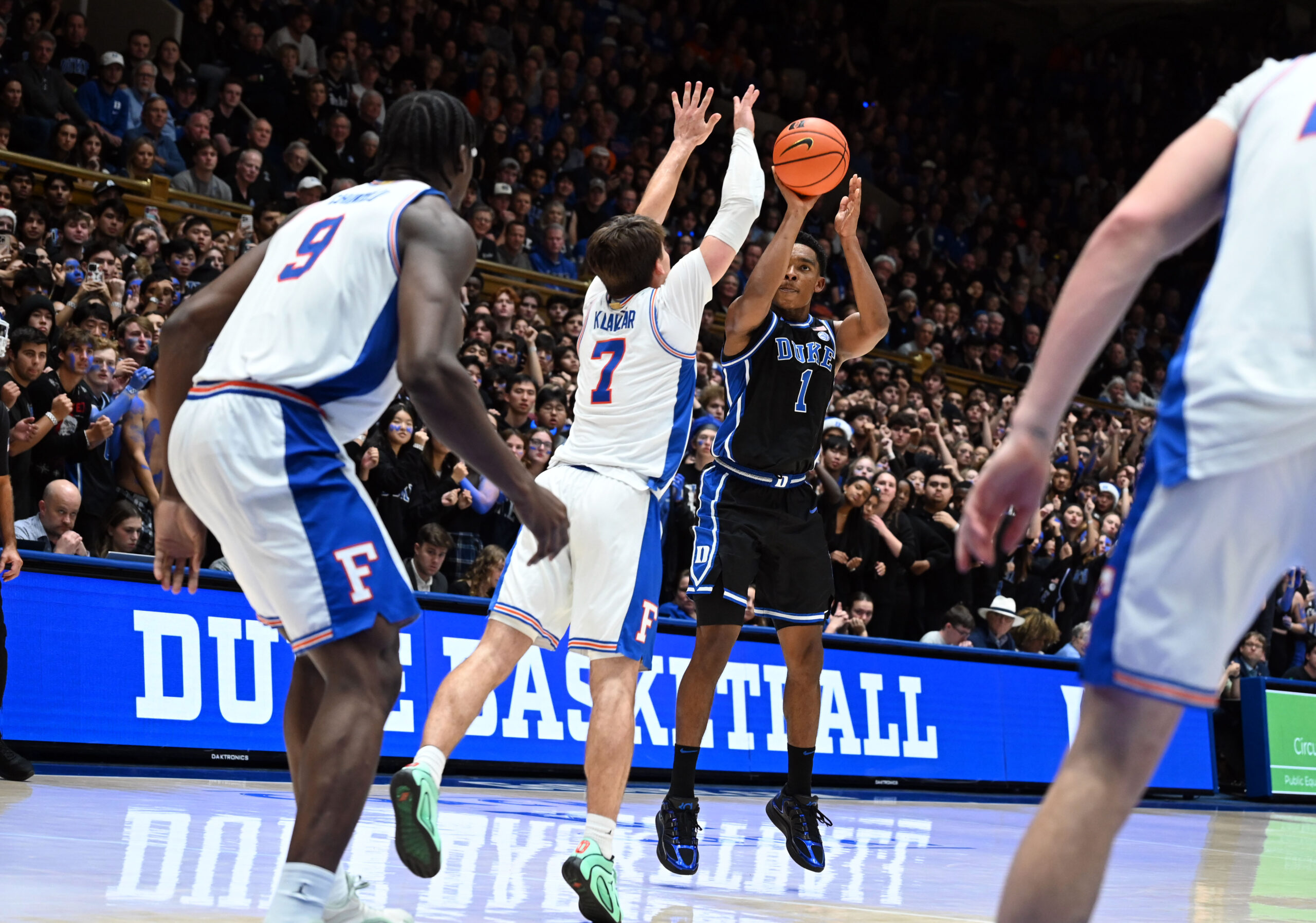 Dec 2, 2025; Durham, North Carolina, USA; Duke Blue Devils guard Caleb Foster (1) shoots over Florida Gators guard Urban Klavzar (7) during the second half at Cameron Indoor Stadium.  The Blue Devils won 67-66. Mandatory Credit: Rob Kinnan-Imagn Images