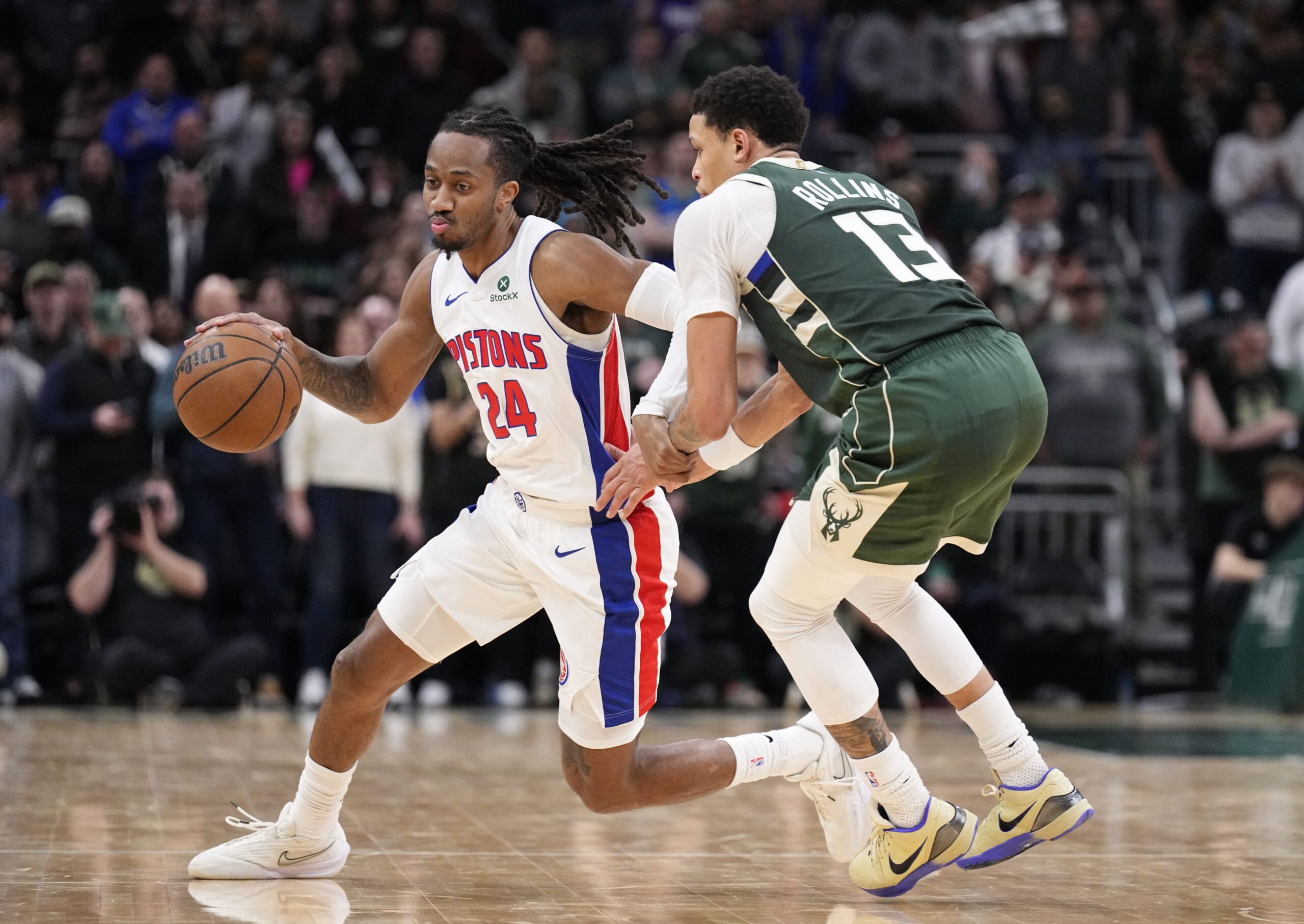 Dec 3, 2025; Milwaukee, Wisconsin, USA; Detroit Pistons guard Daniss Jenkins (24) brings the ball up the court against Milwaukee Bucks guard Ryan Rollins (13) in the second half at Fiserv Forum. Mandatory Credit: Michael McLoone-Imagn Images