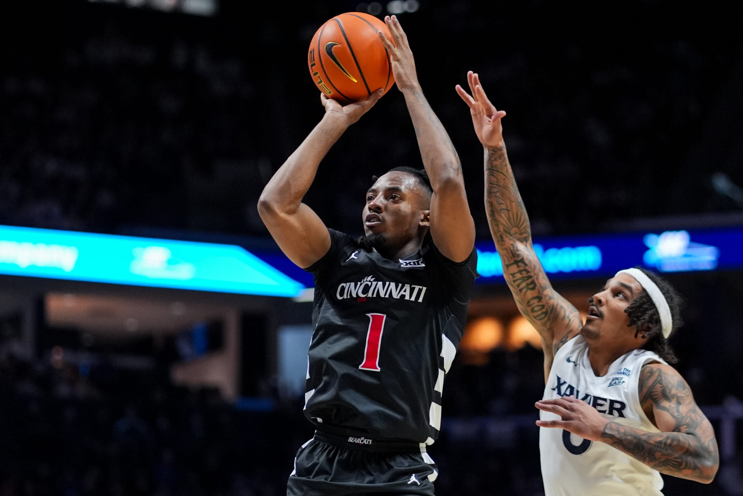 Dec 5, 2025; Cincinnati, Ohio, USA; Cincinnati Bearcats guard Day Day Thomas (1) shoots against Xavier Musketeers guard Roddie Anderson III (0) in the second half at the Cintas Center. Mandatory Credit: Aaron Doster-Imagn Images