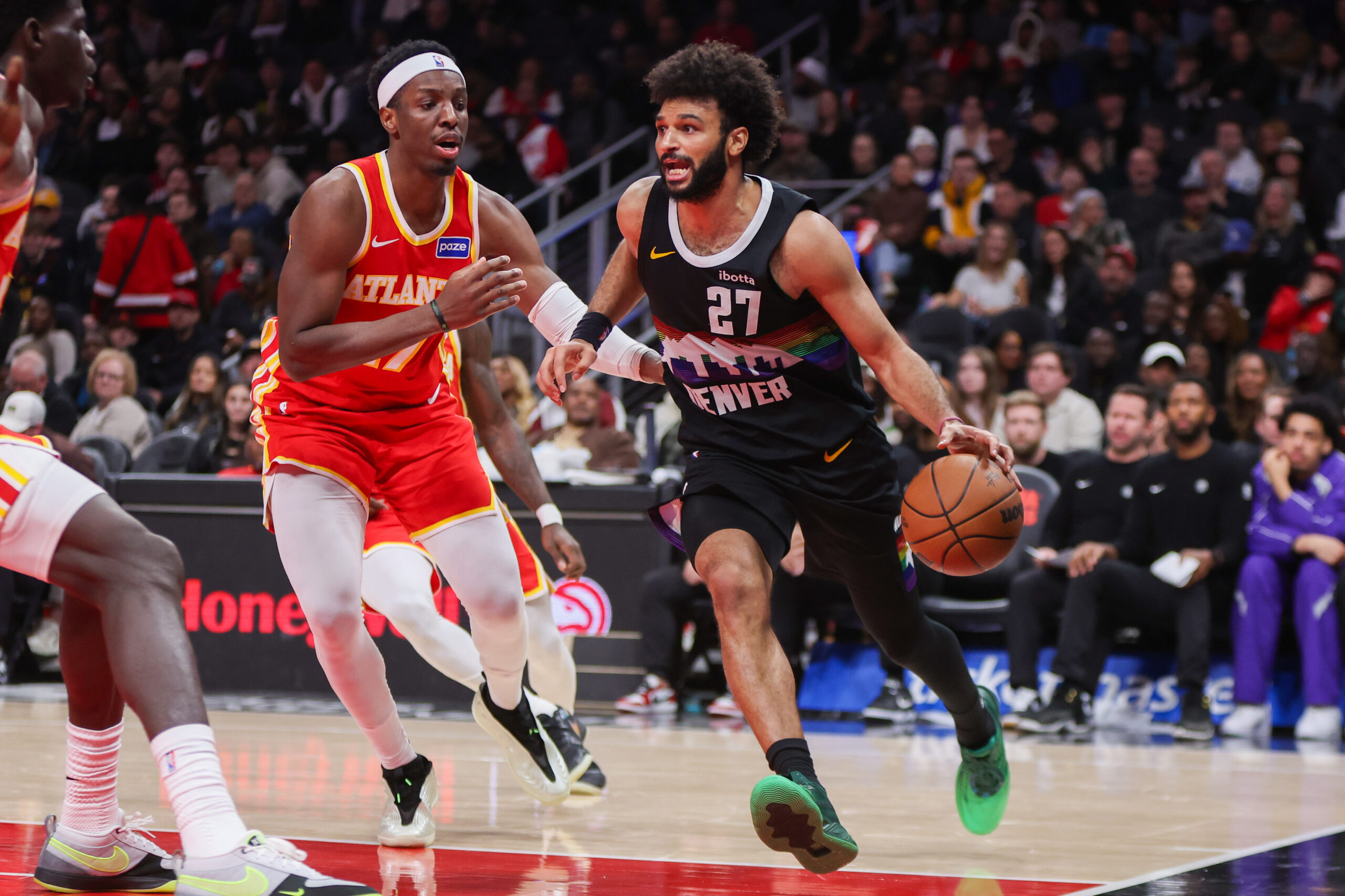 Dec 5, 2025; Atlanta, Georgia, USA; Denver Nuggets guard Jamal Murray (27) drives on Atlanta Hawks forward Onyeka Okongwu (17) in the fourth quarter at State Farm Arena. Mandatory Credit: Brett Davis-Imagn Images