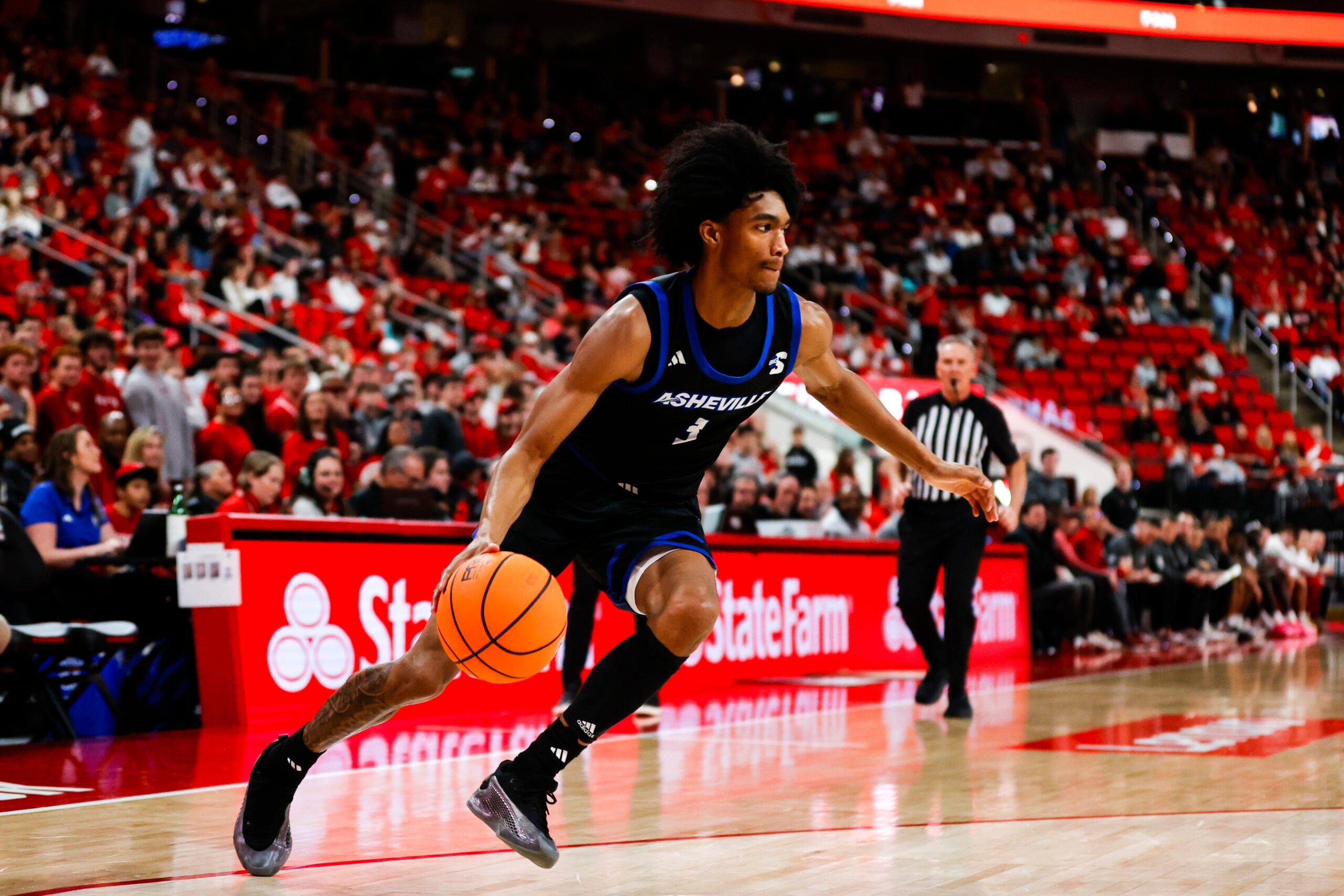 Dec 6, 2025; Raleigh, North Carolina, USA; UNC Asheville Bulldogs guard Kameron Taylor (3) dribbles the ball during the second half of the game against NC State Wolfpack at Lenovo Center. Mandatory Credit: Jaylynn Nash-Imagn Images
