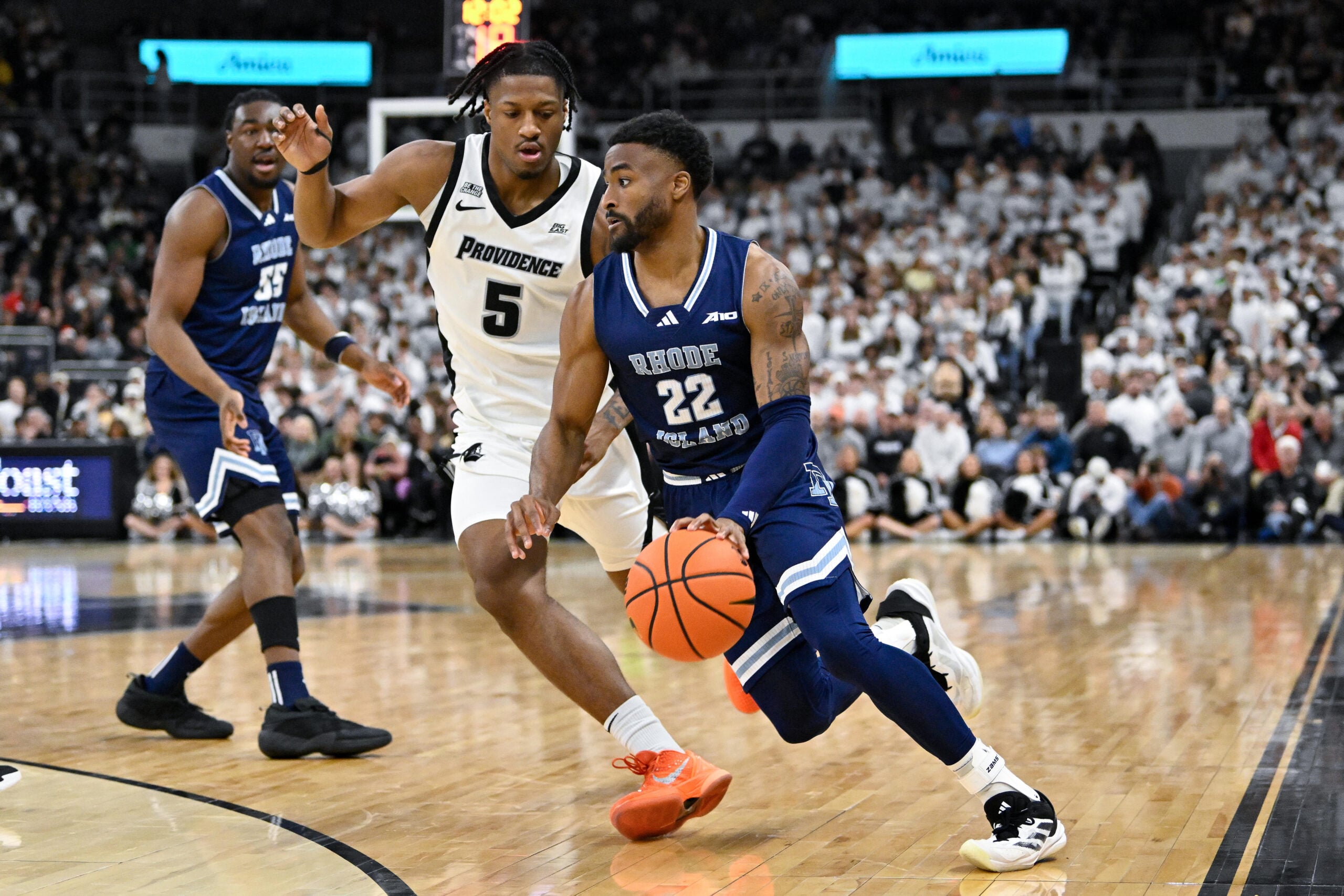 Dec 6, 2025; Providence, Rhode Island, USA; Rhode Island Rams guard RJ Johnson (22) drives to the basket against Providence Friars forward Jamier Jones (5) during the second half at Amica Mutual Pavilion. Mandatory Credit: Eric Canha-Imagn Images